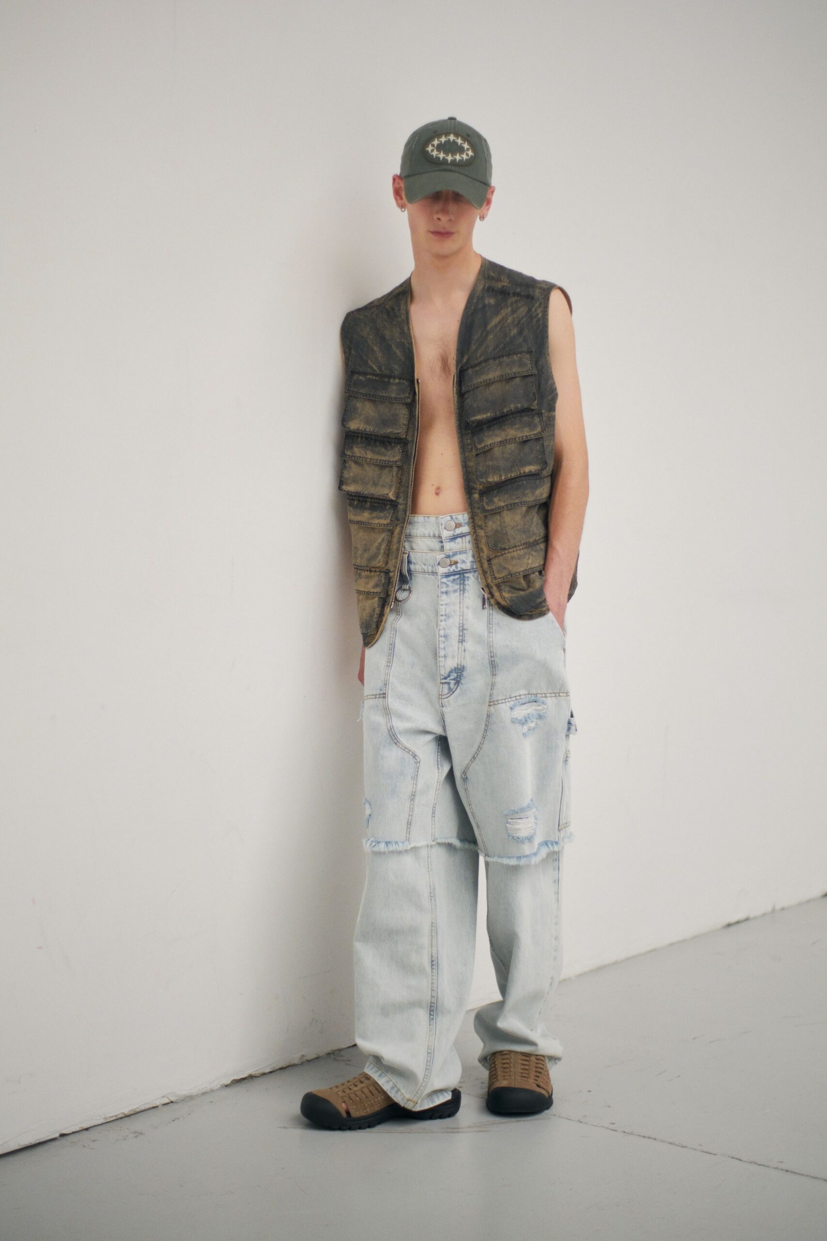 brown denim vest with distressed pants
