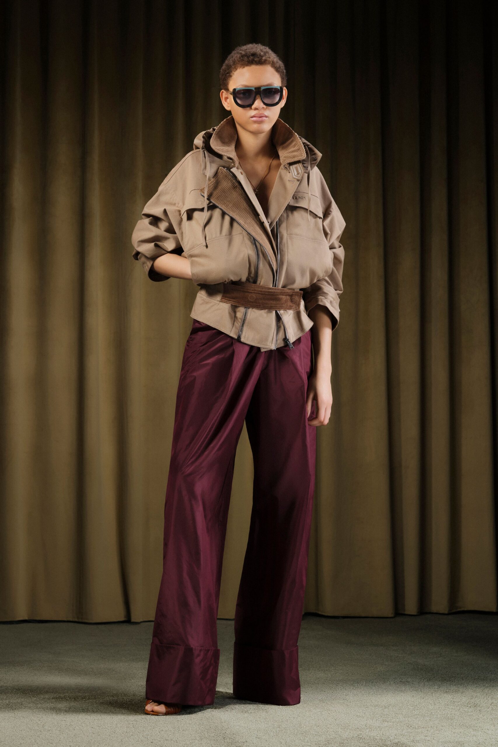 beige relaxed jacket with maroon wide-leg pants