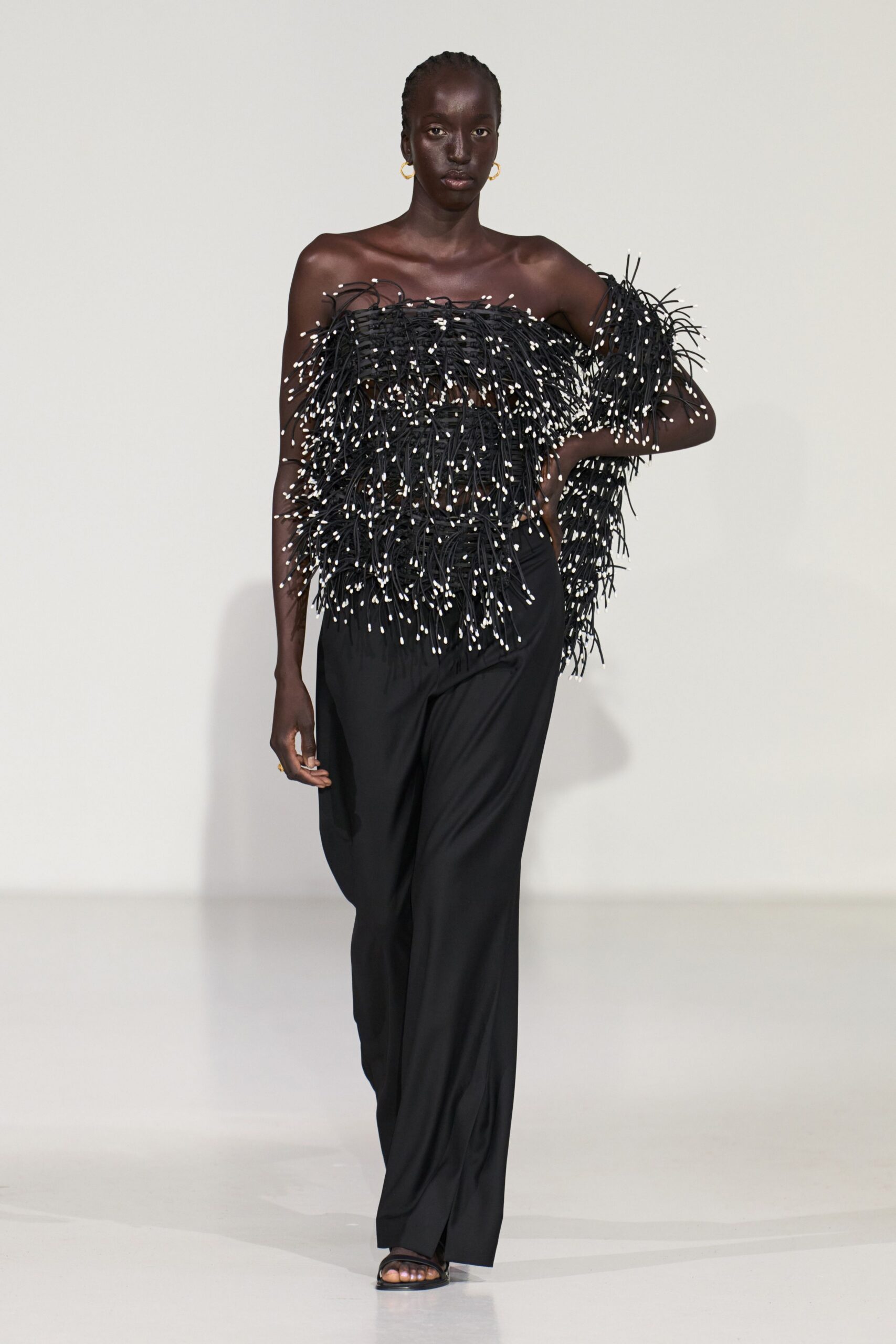 black fringed top with relaxed pants