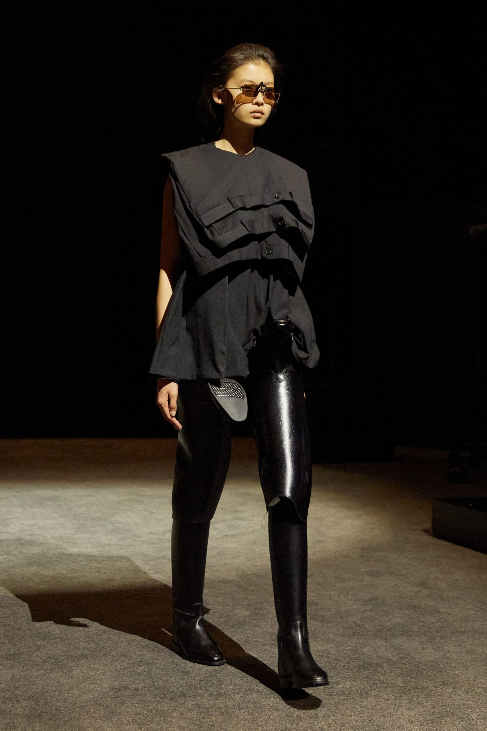 black relaxed top with vinyl pants