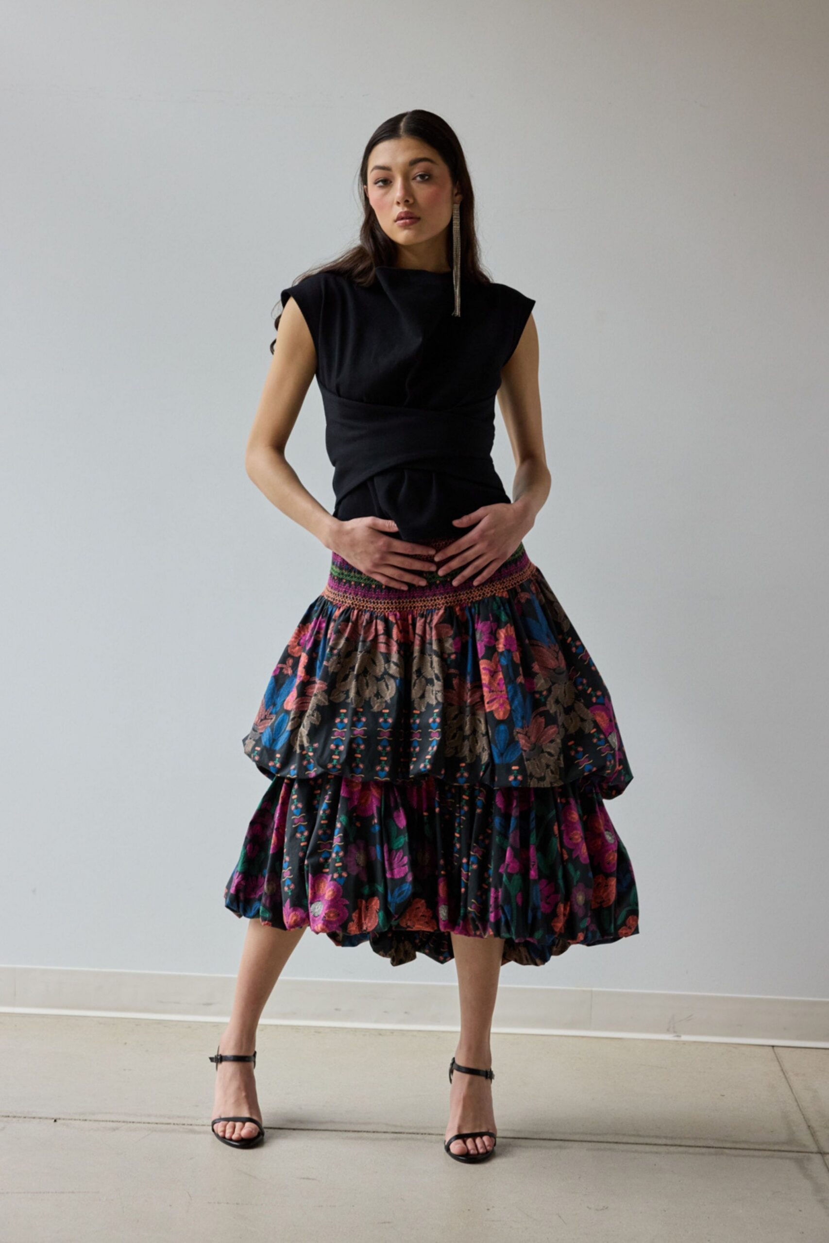 black fitted top with multi-tiered skirt
