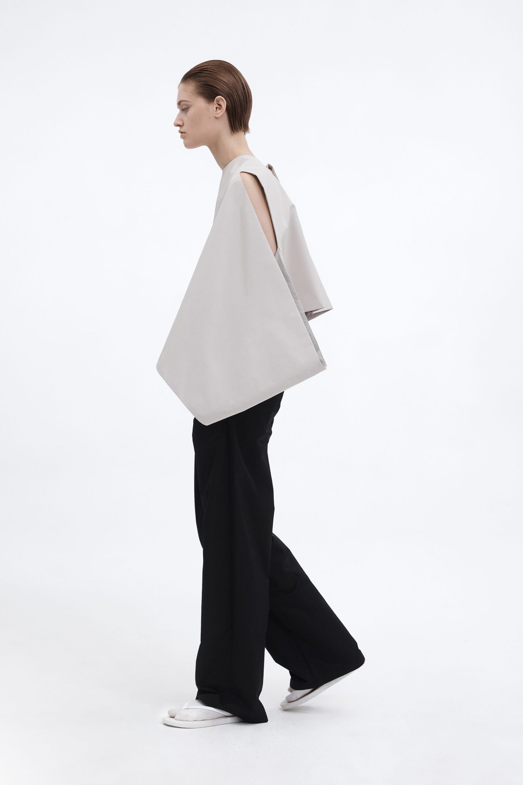 gray asymmetric top with black pants