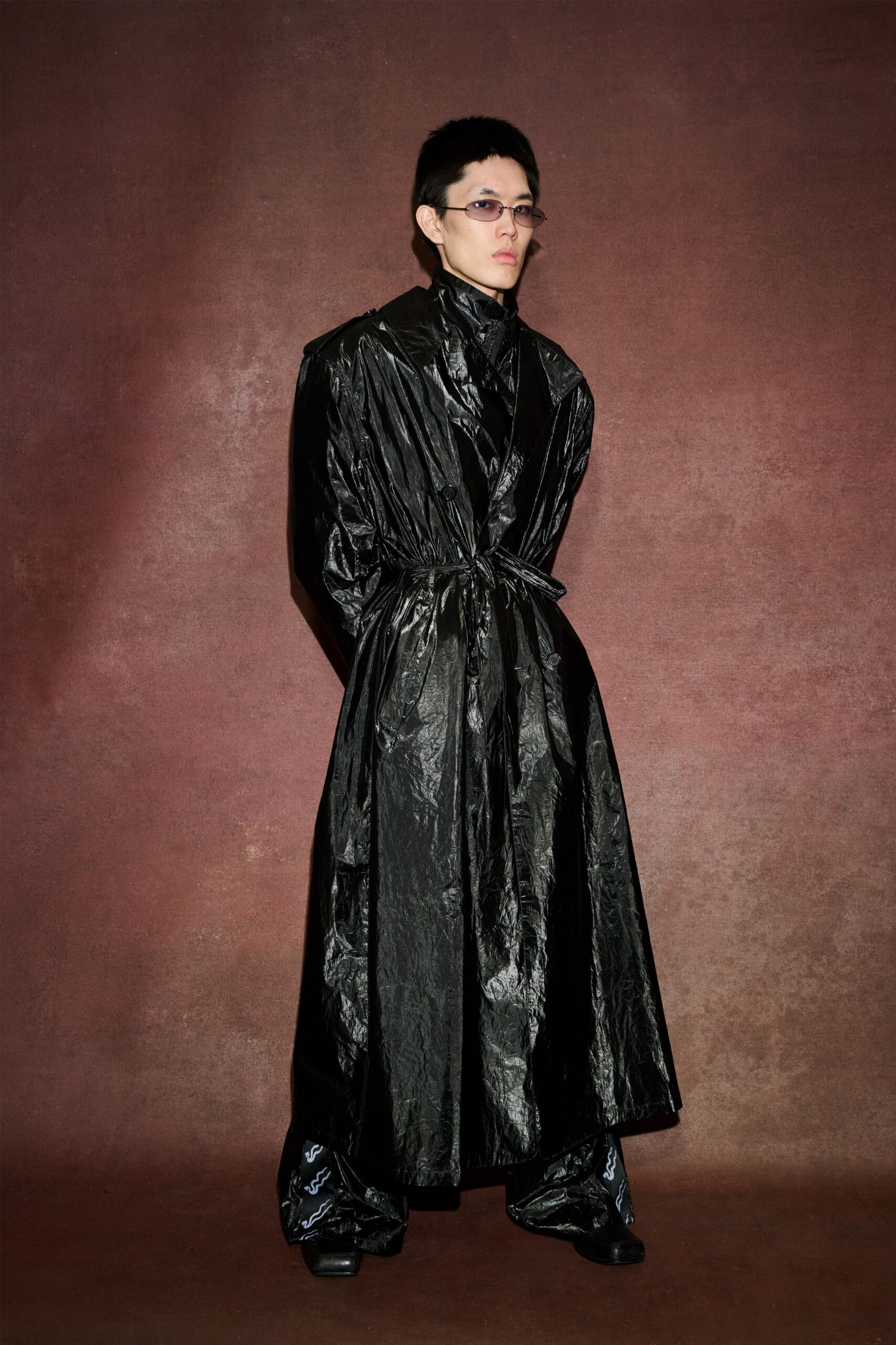 black vinyl long-sleeve collared relaxed belted shiny trench