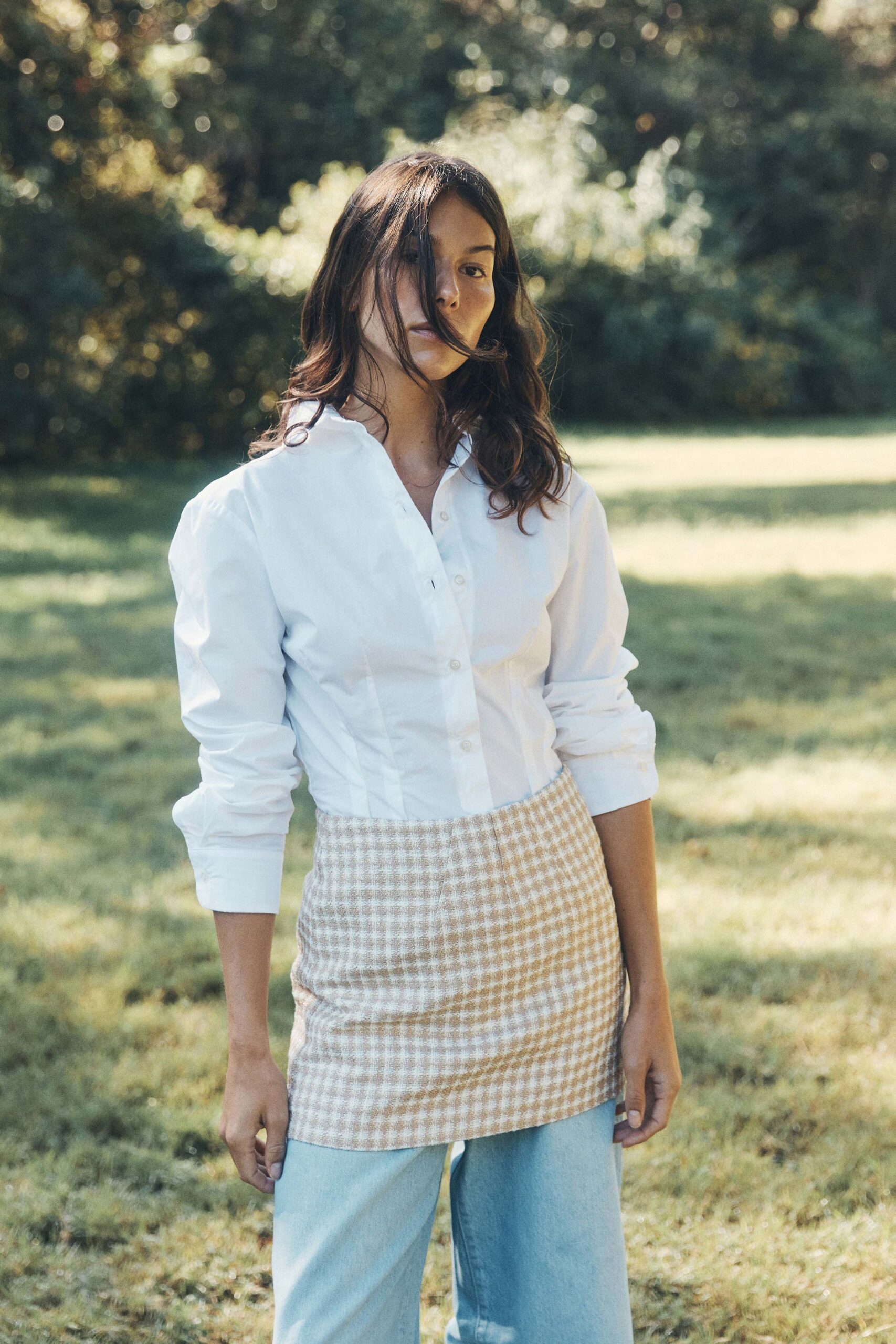 white shirt beige checked skirt blue jeans