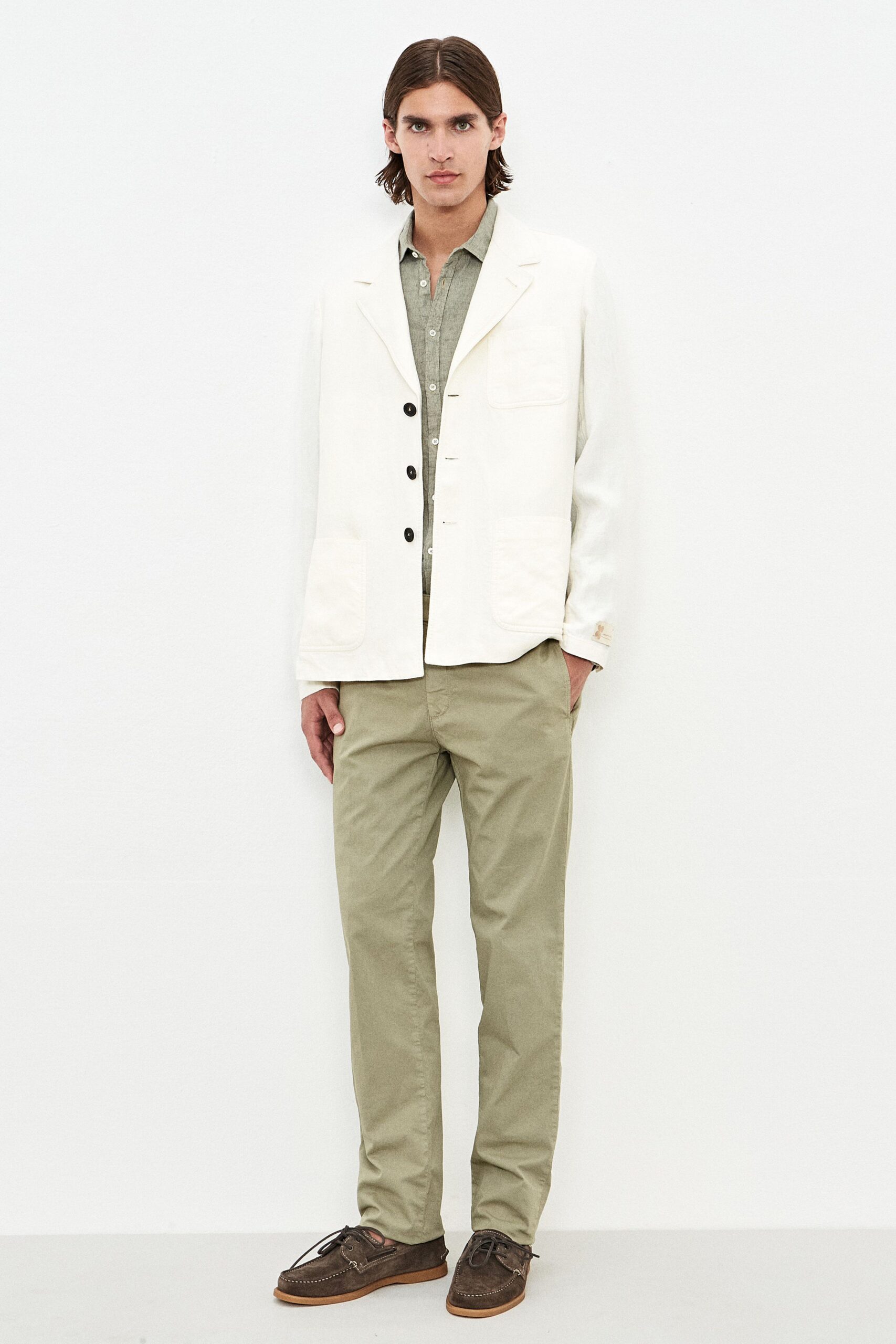 white blazer green shirt beige pants