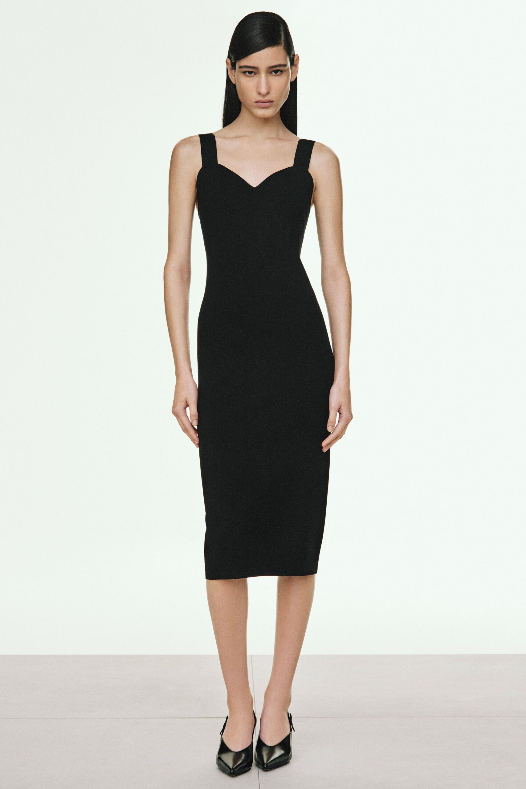 black fitted midi dress with heels