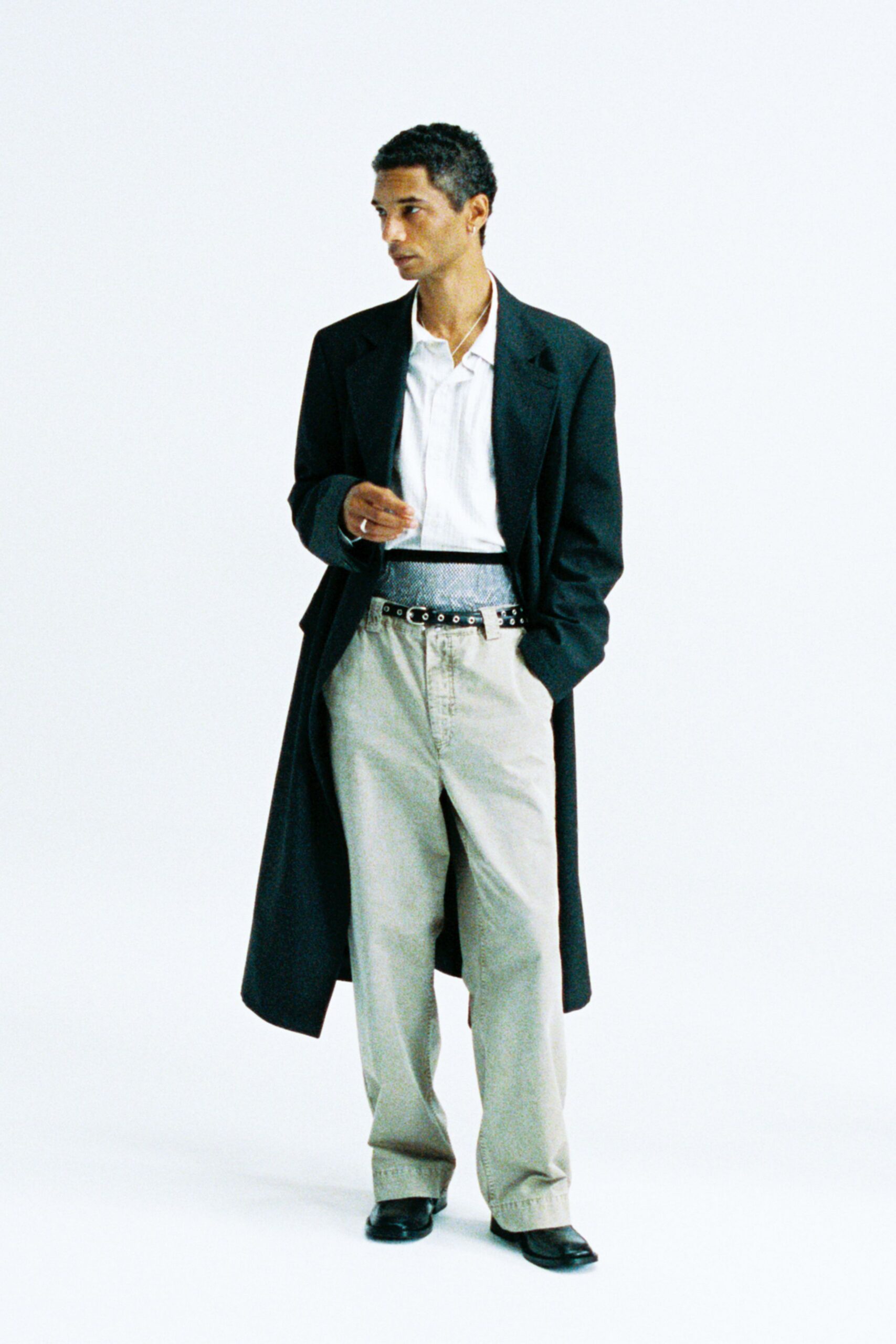 black wool coat with beige pants