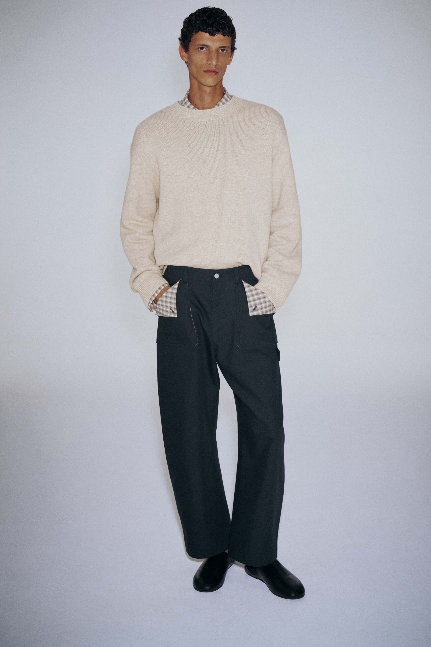 beige wool sweater with black pants