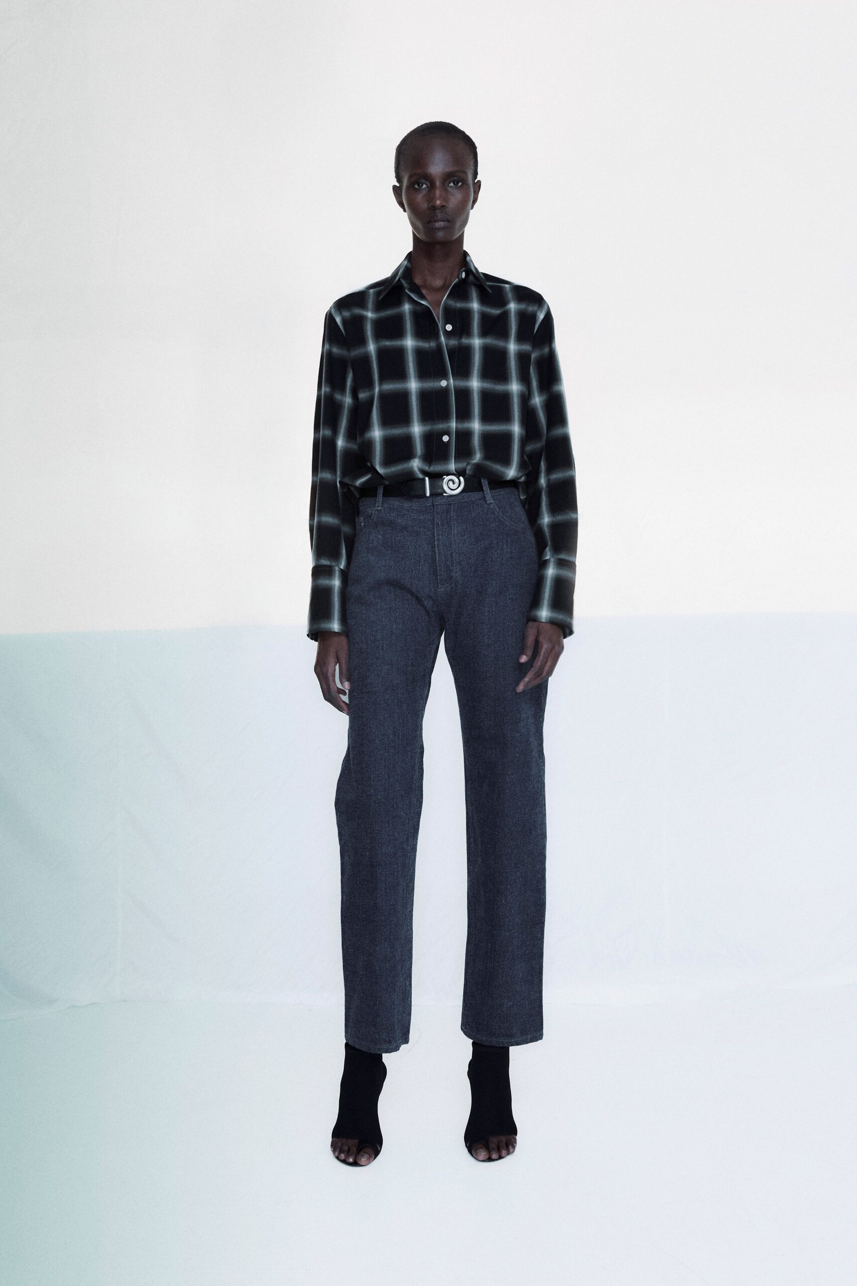 black and white checked shirt with gray pants