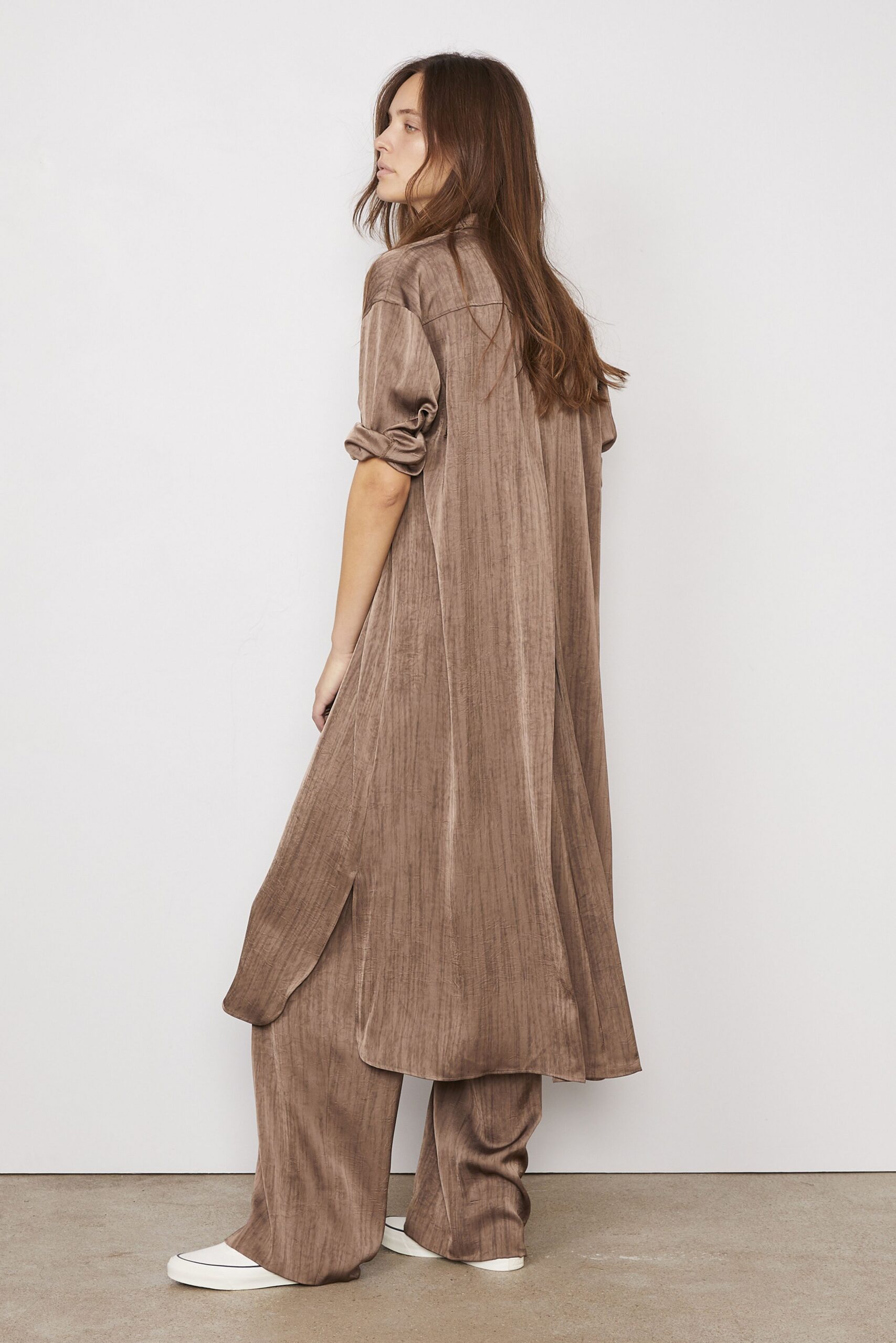 brown shirt-dress with white shoes
