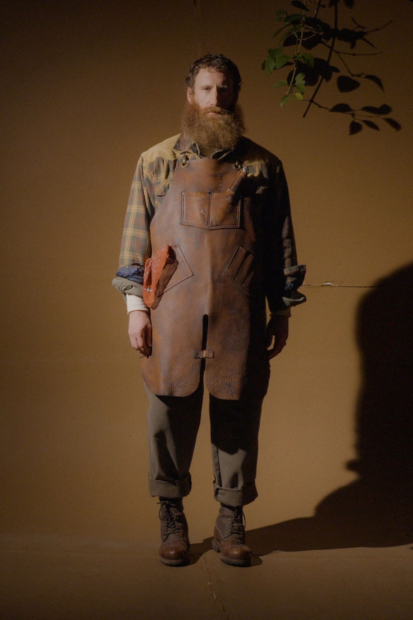 brown checked shirt with leather apron