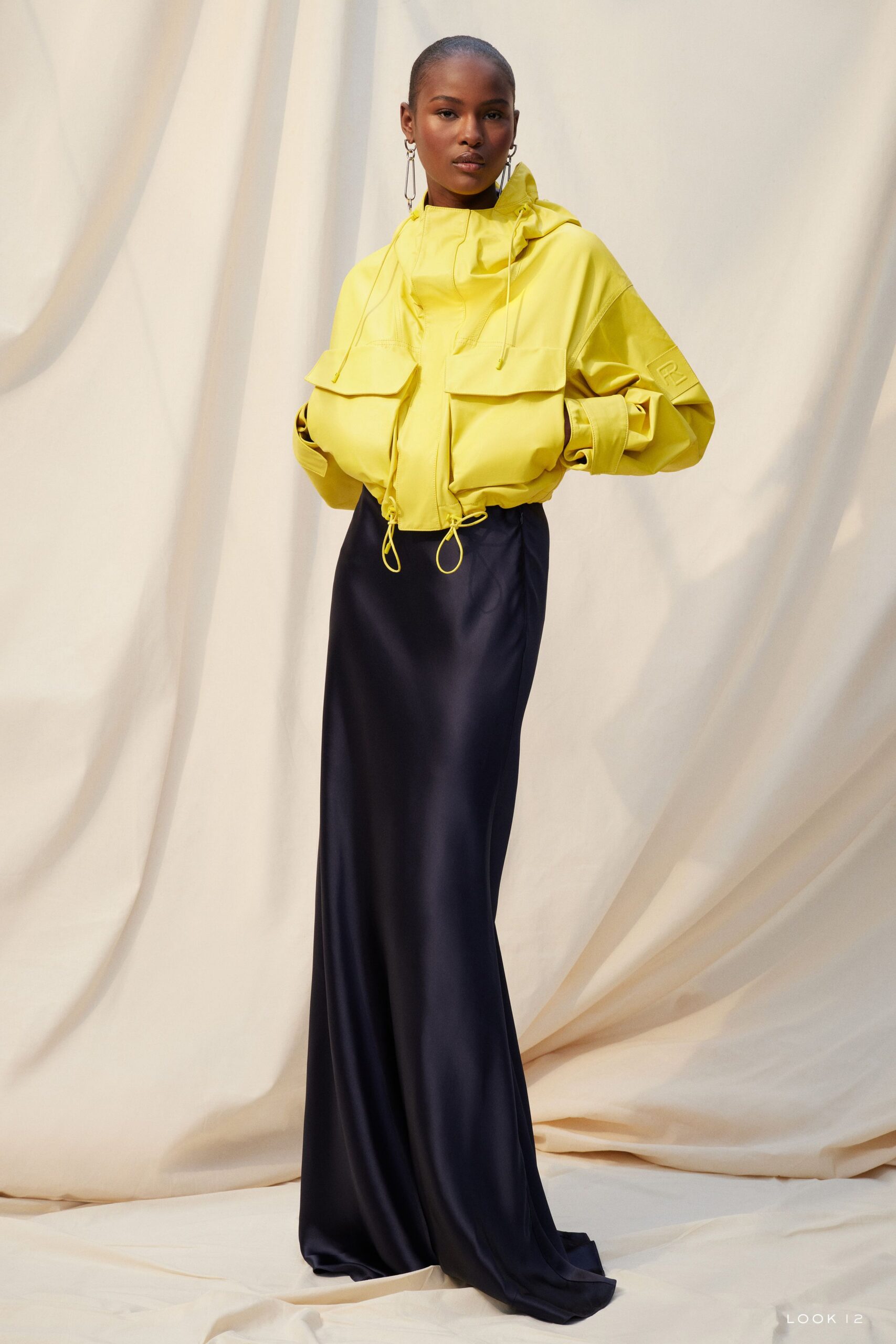 yellow hooded jacket and navy skirt