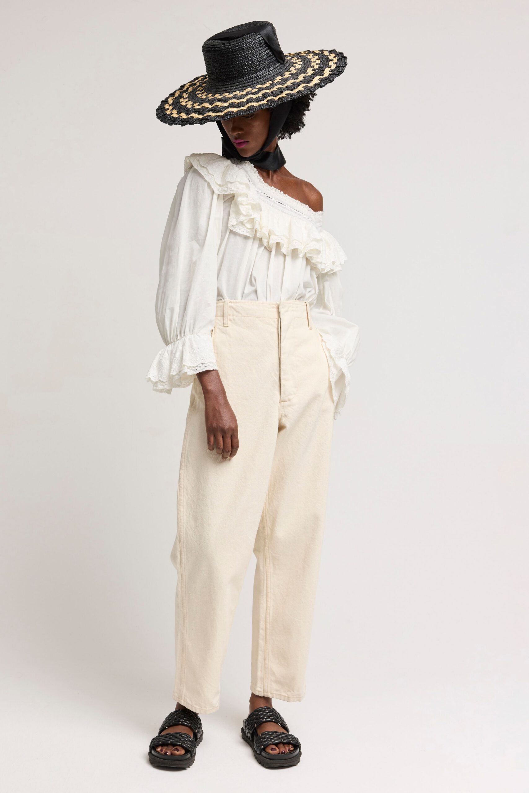 white ruffled blouse with beige pants
