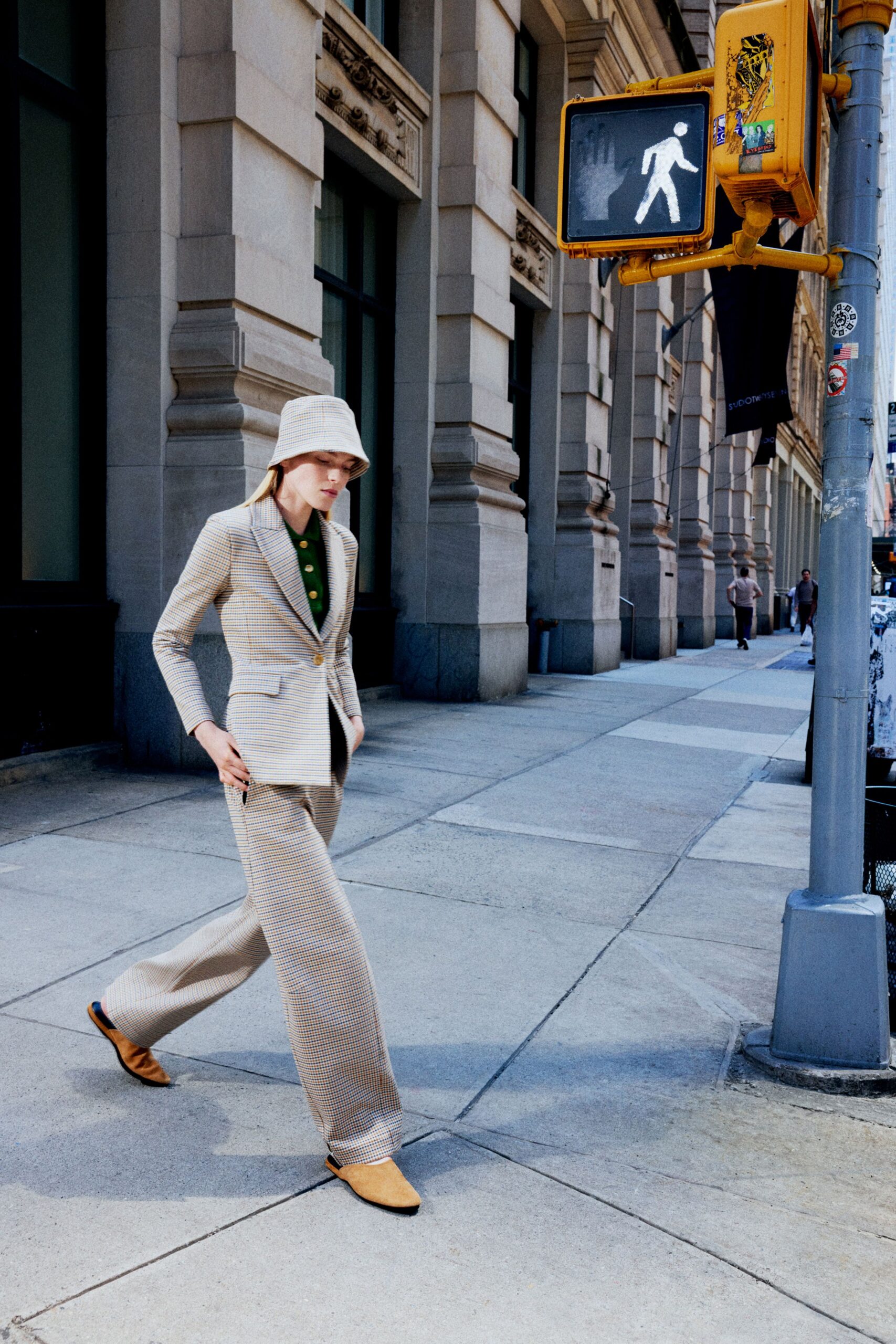 beige tailored suit with green shirt