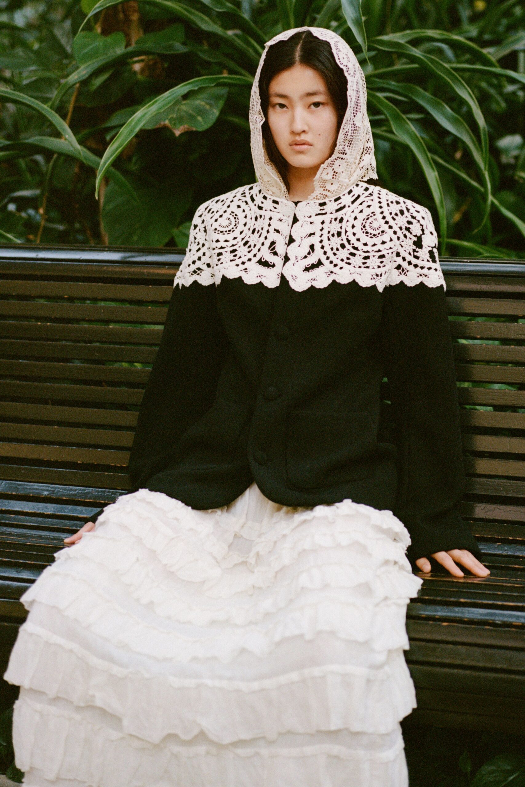 black wool coat with white ruffled dress