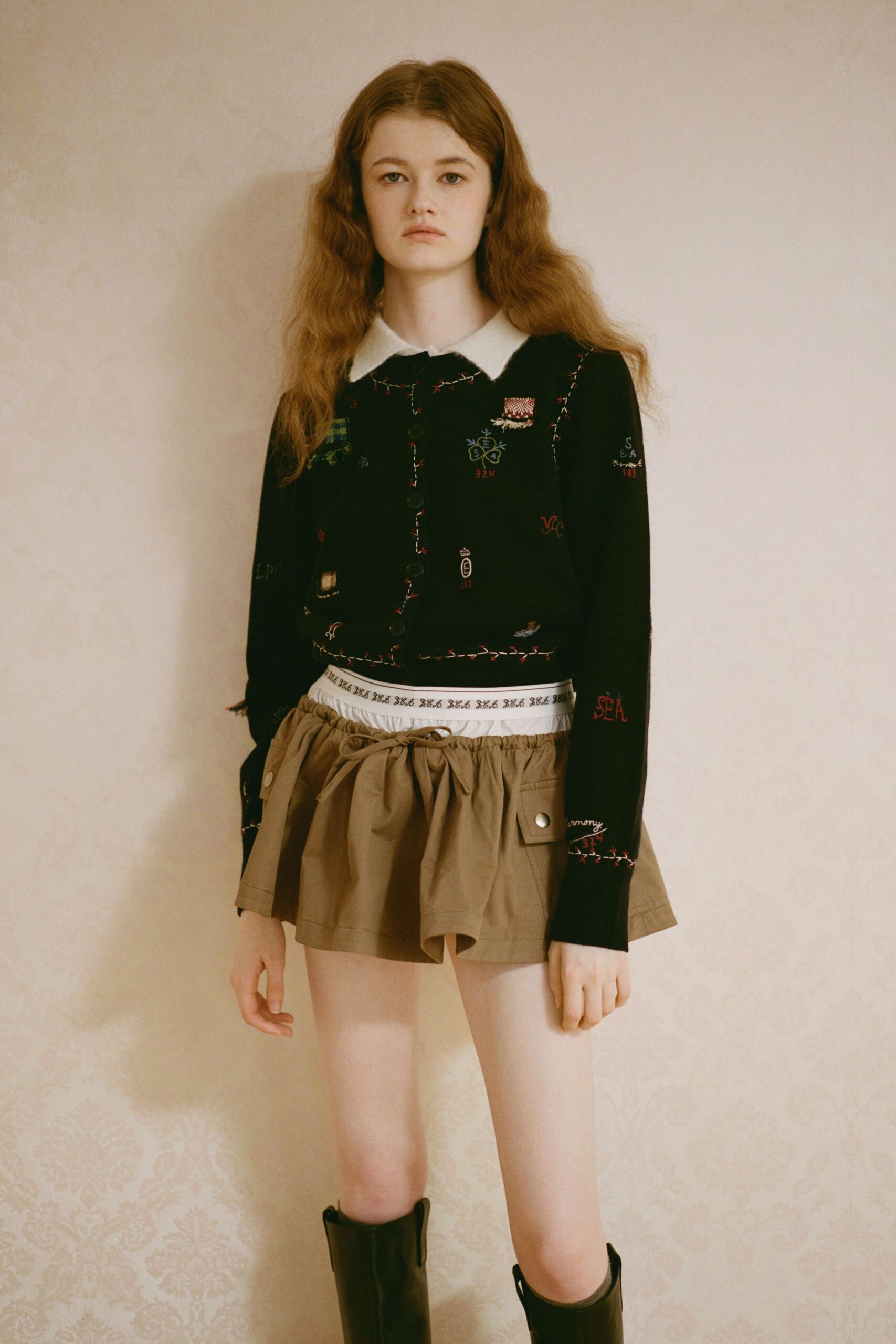 black embroidered sweater beige skirt