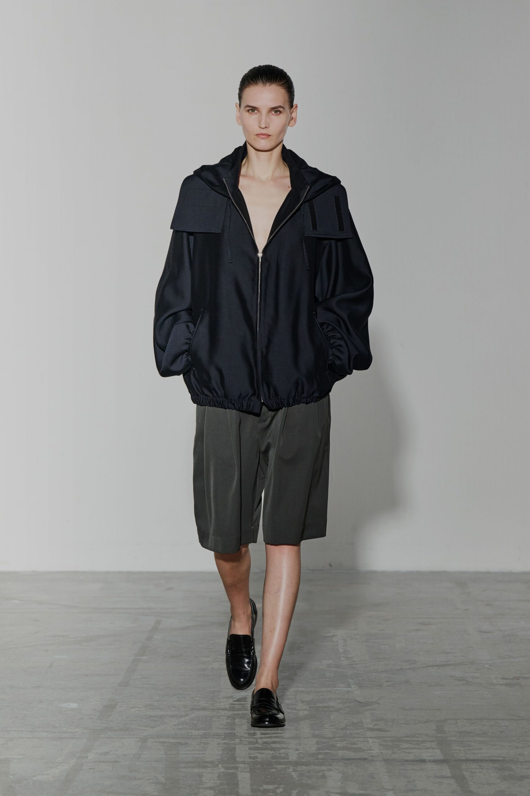 black silk relaxed jacket with gray shorts