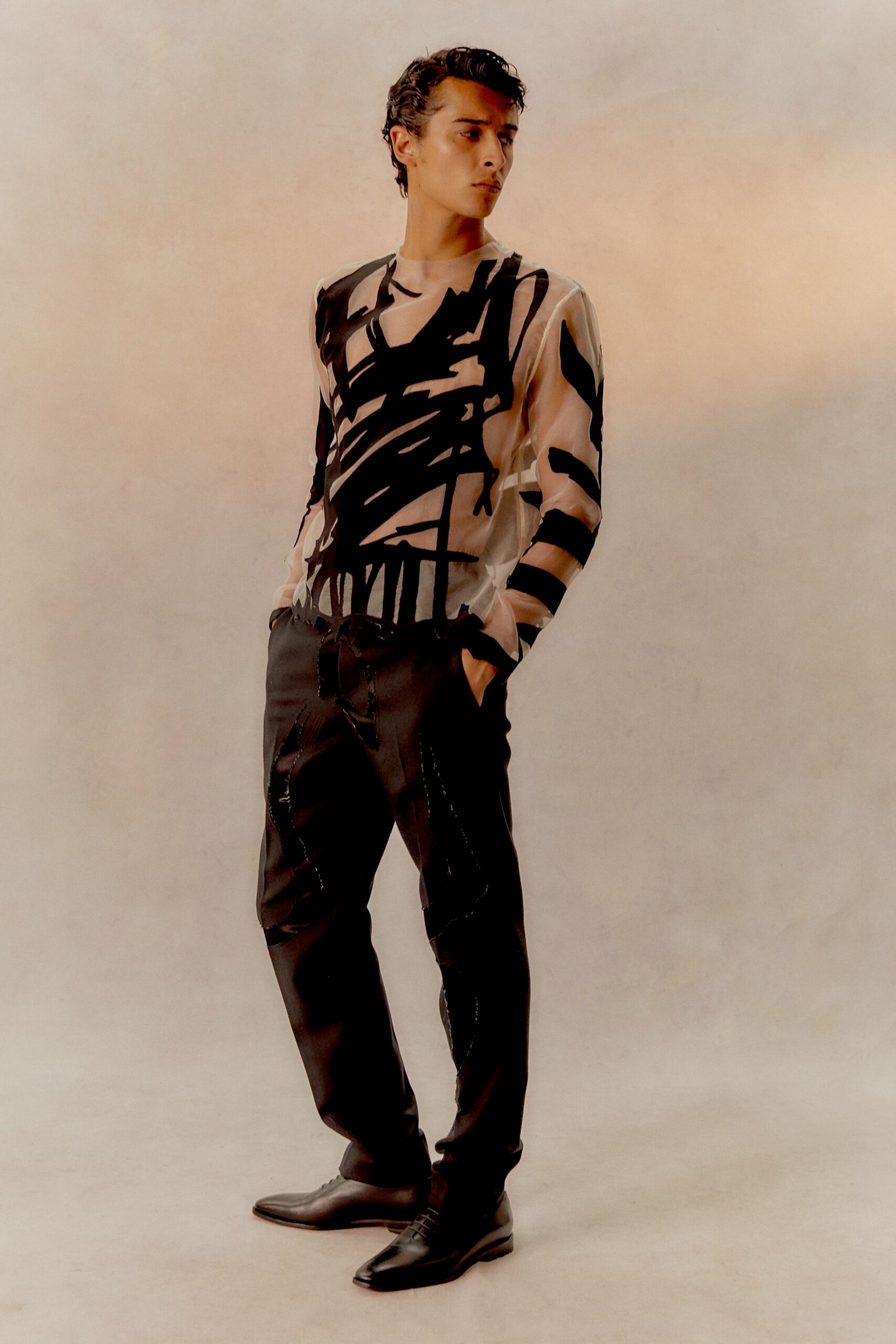beige printed long-sleeve top with black pants