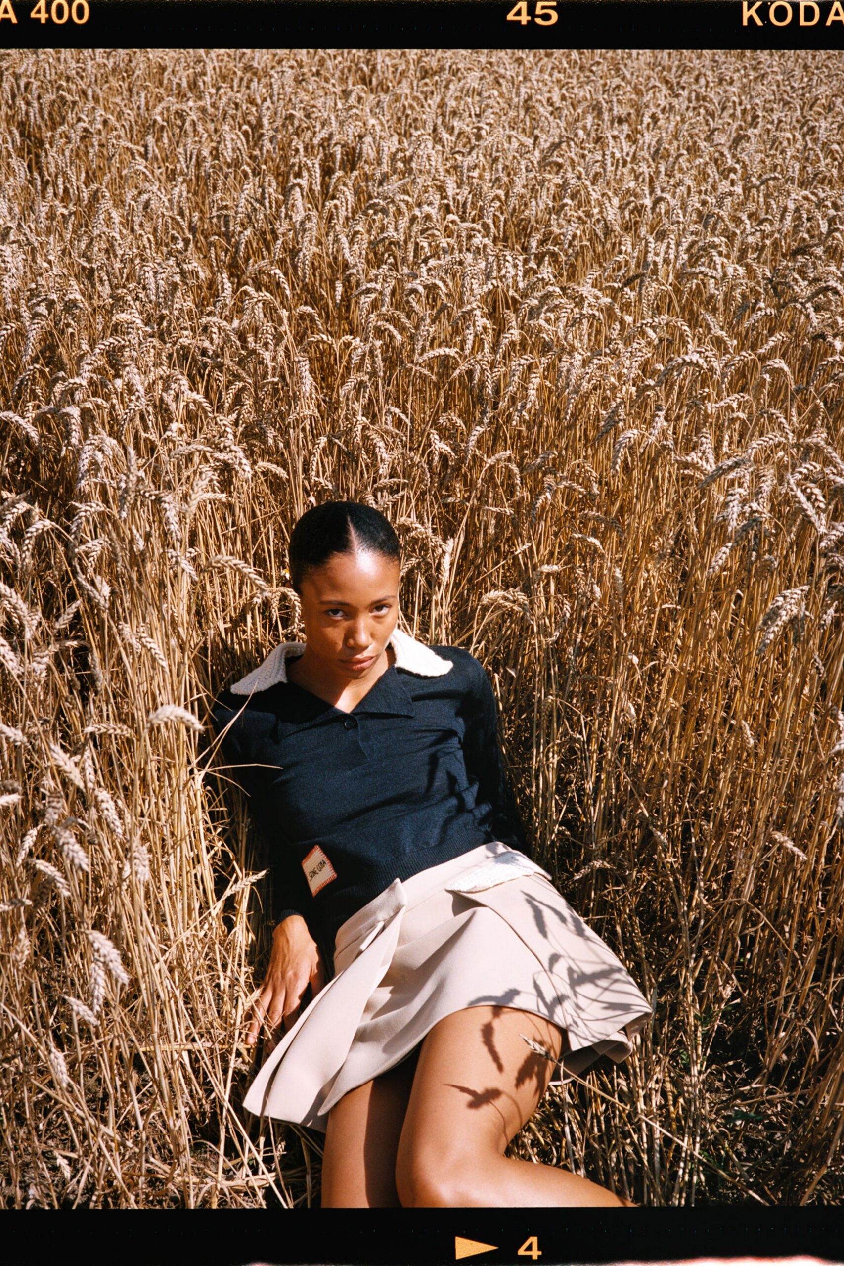 black fitted top beige pleated skirt