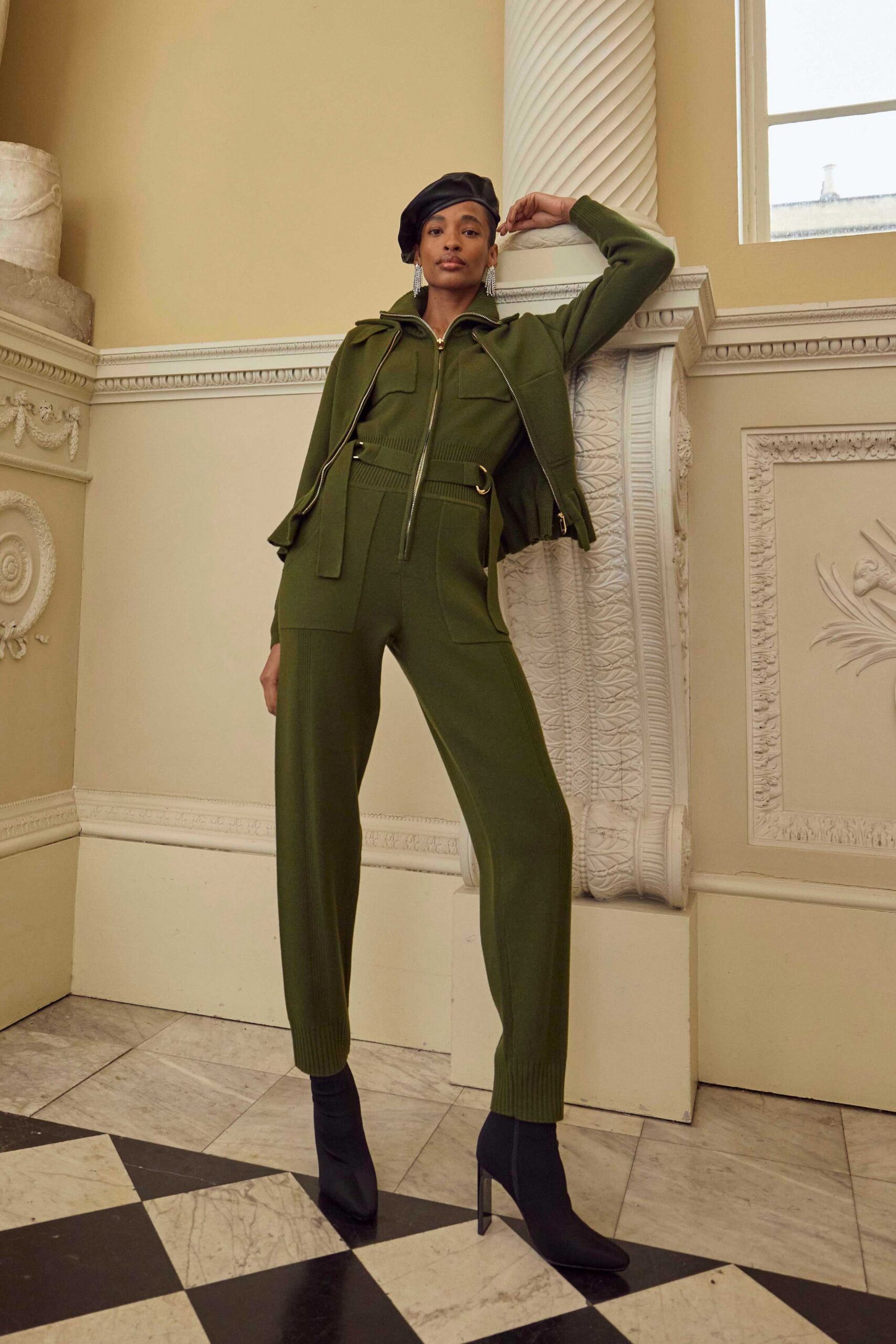 green fitted jumpsuit with black boots