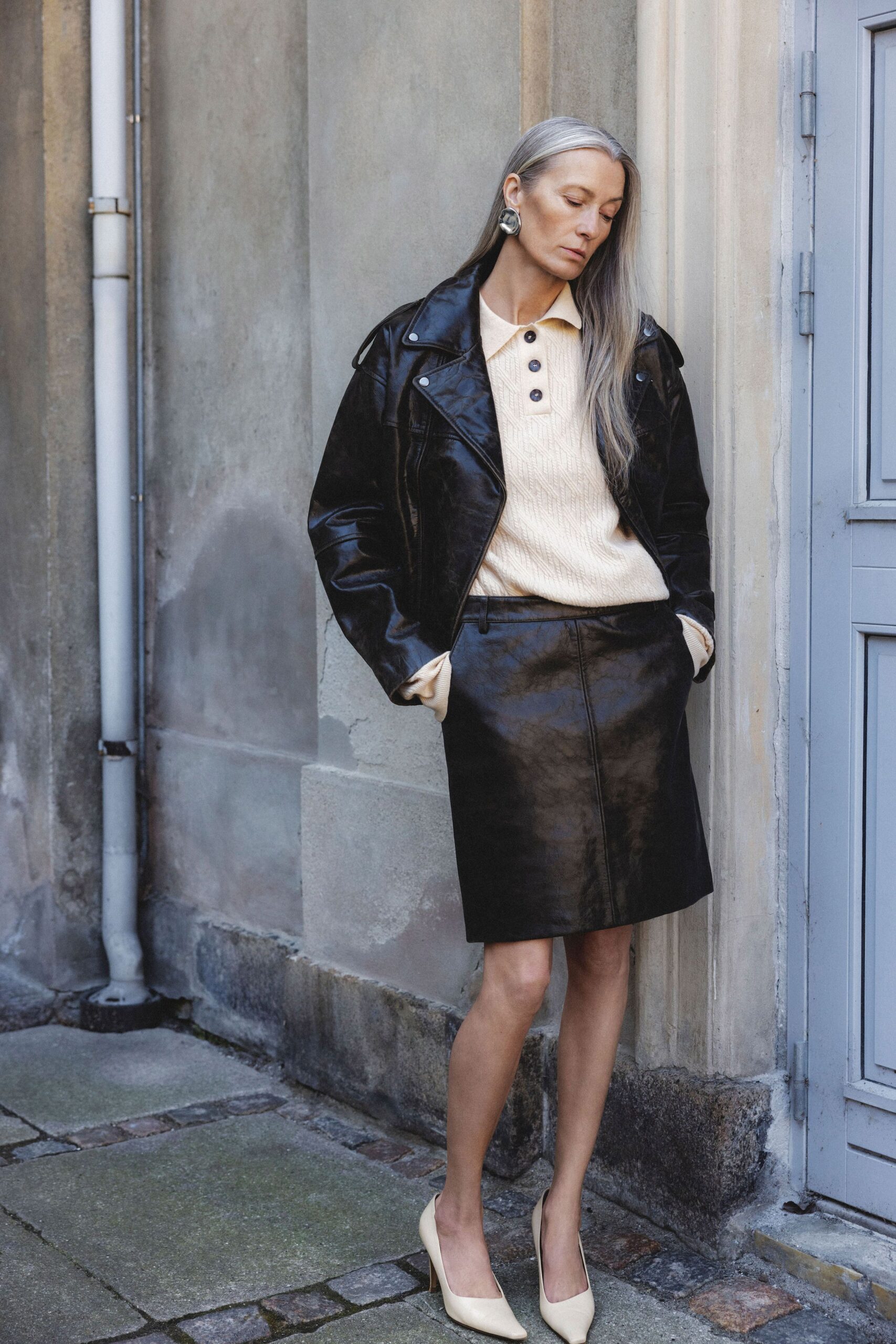 black leather jacket beige top mini skirt