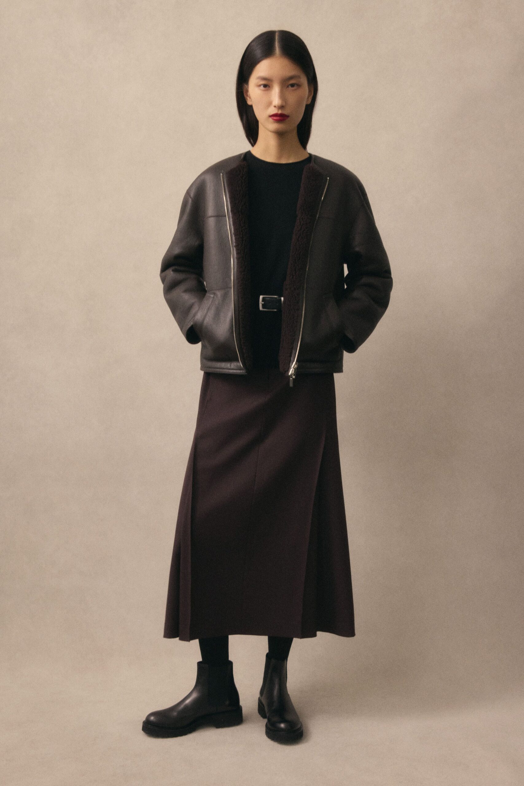 black leather jacket with brown skirt
