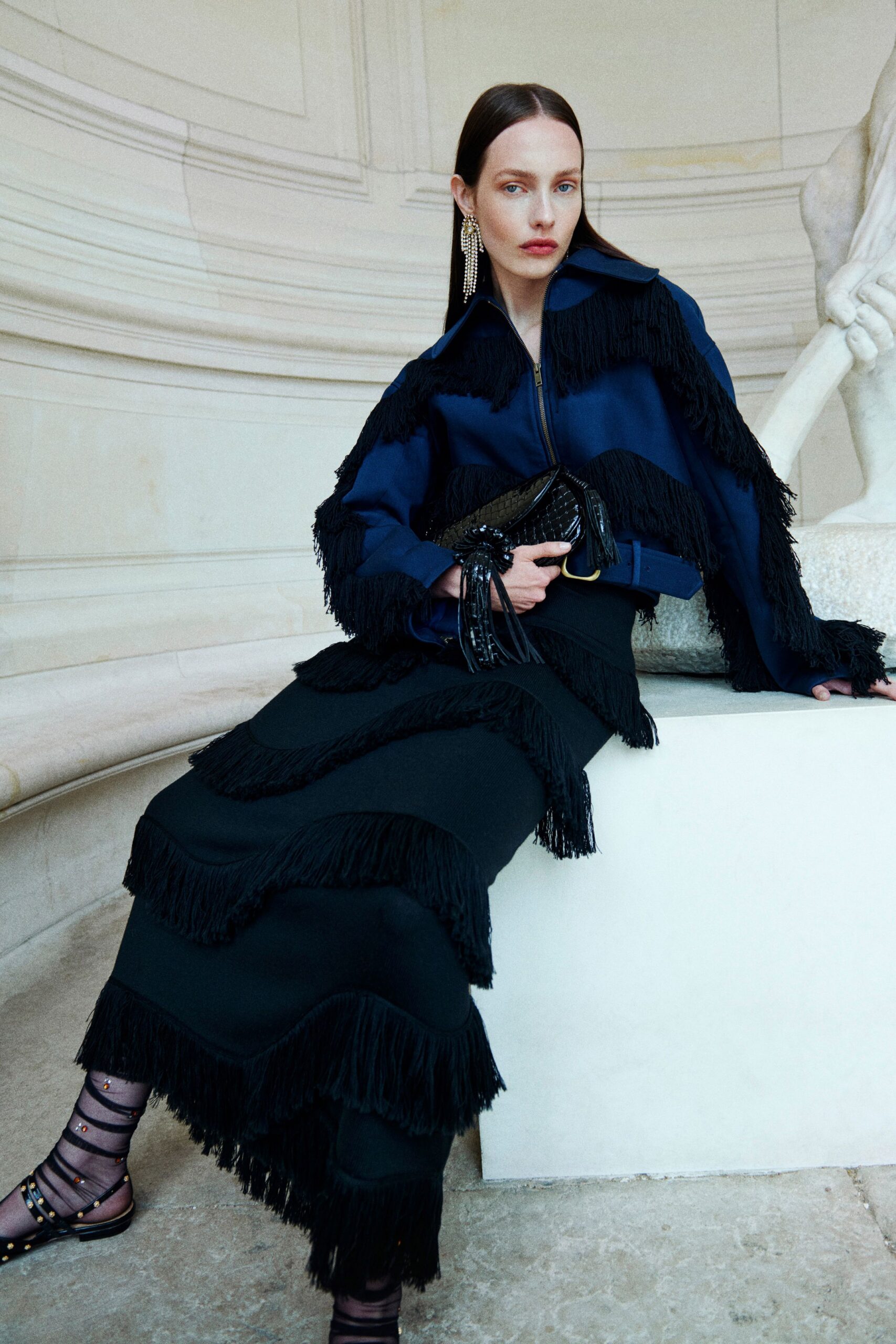blue fringed jacket and black skirt