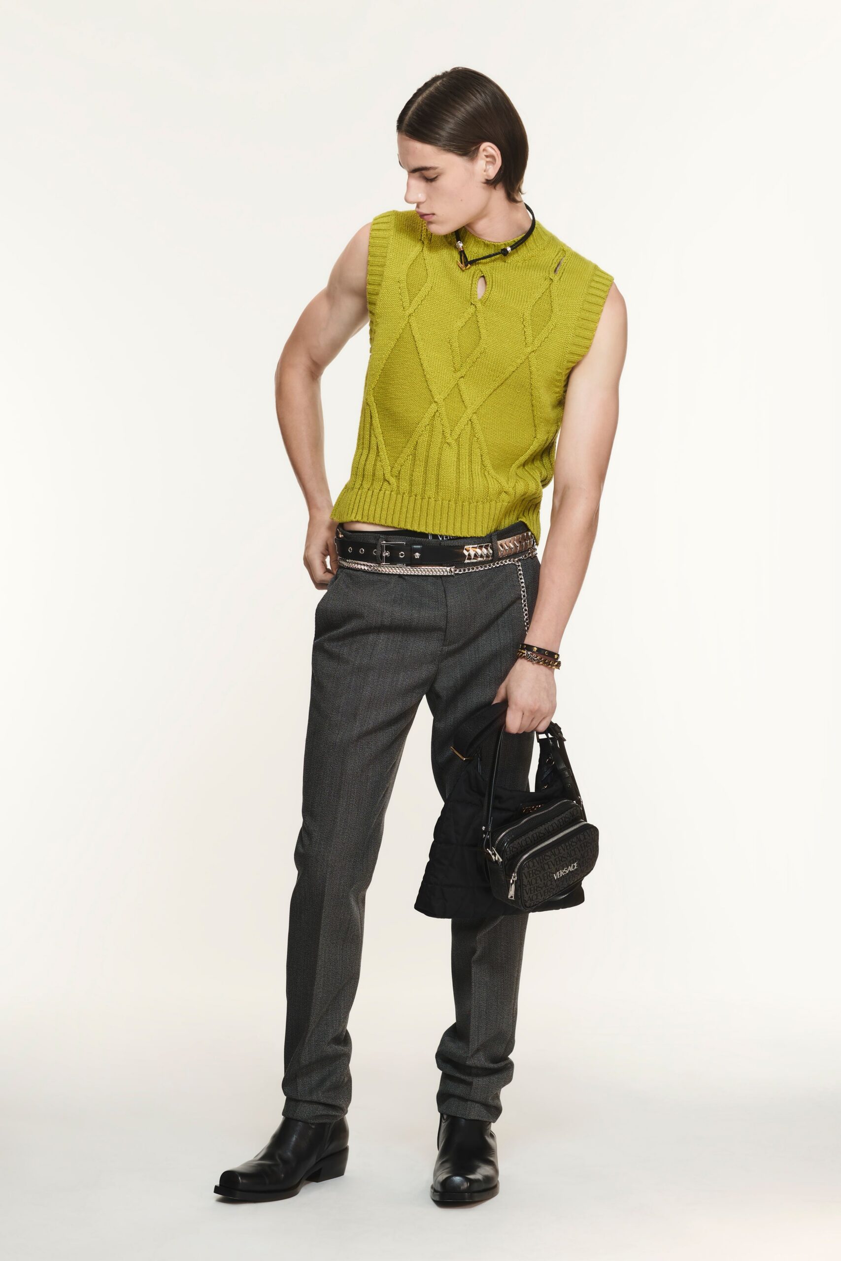 green knitted sleeveless top with gray pants