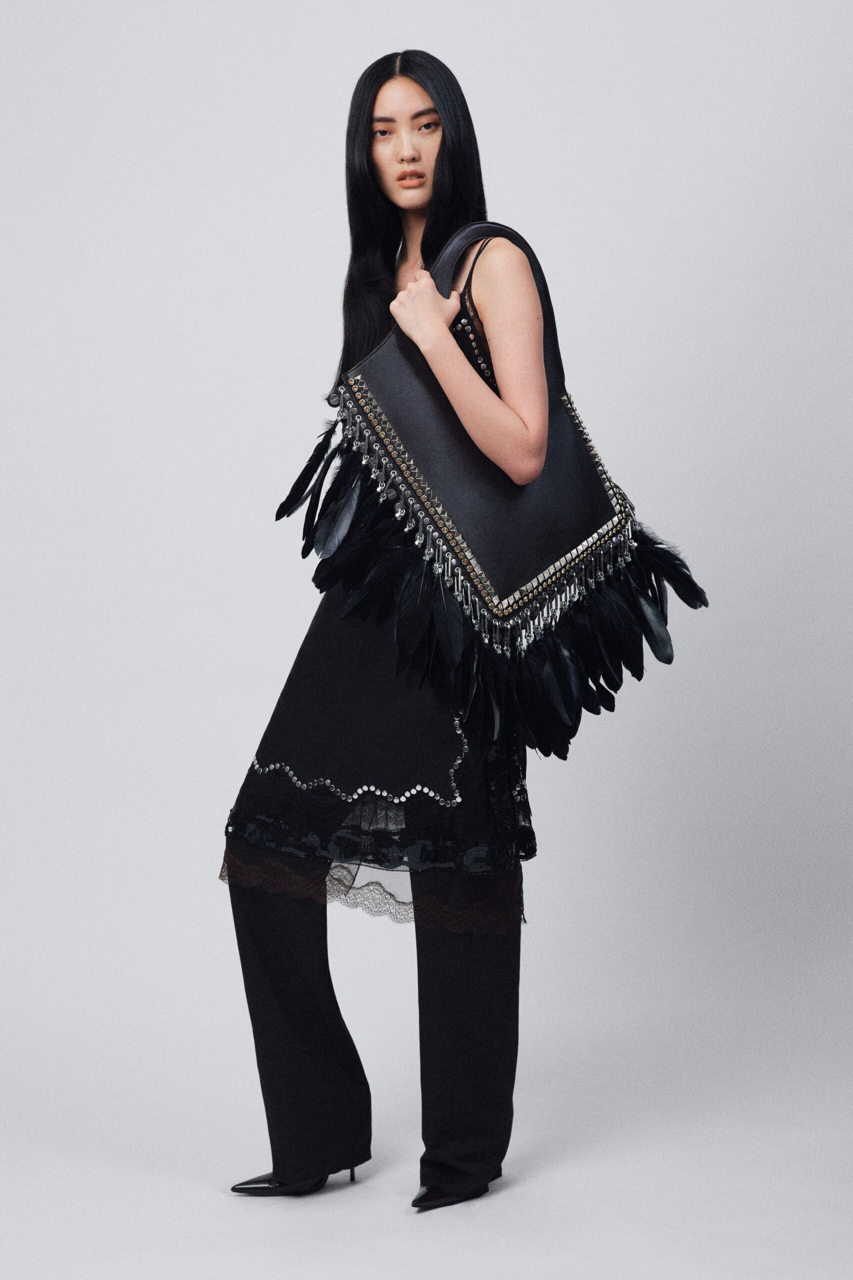black silk sleeveless dress with fringed bag