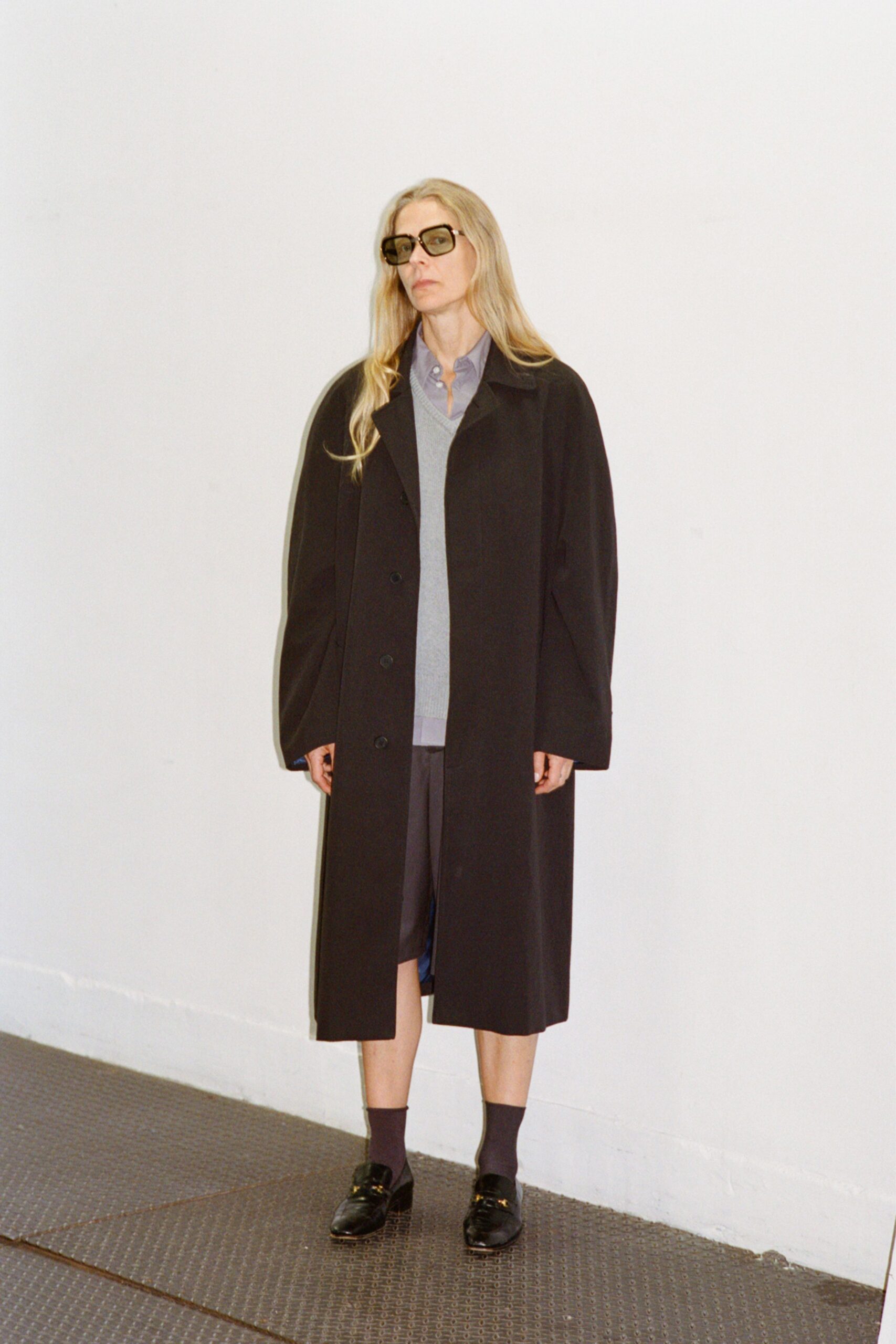 black wool coat with gray sweater