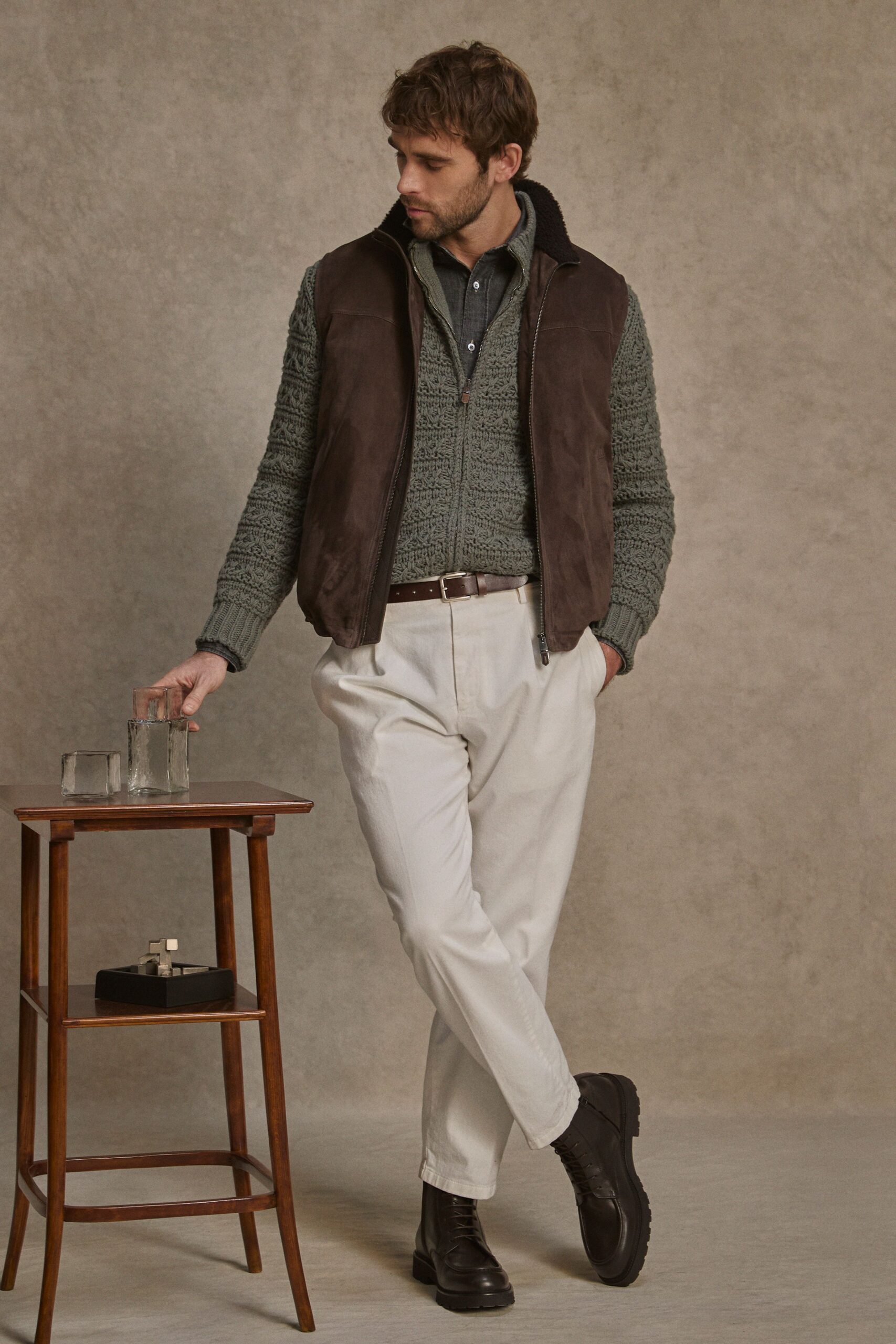 brown leather vest with green sweater