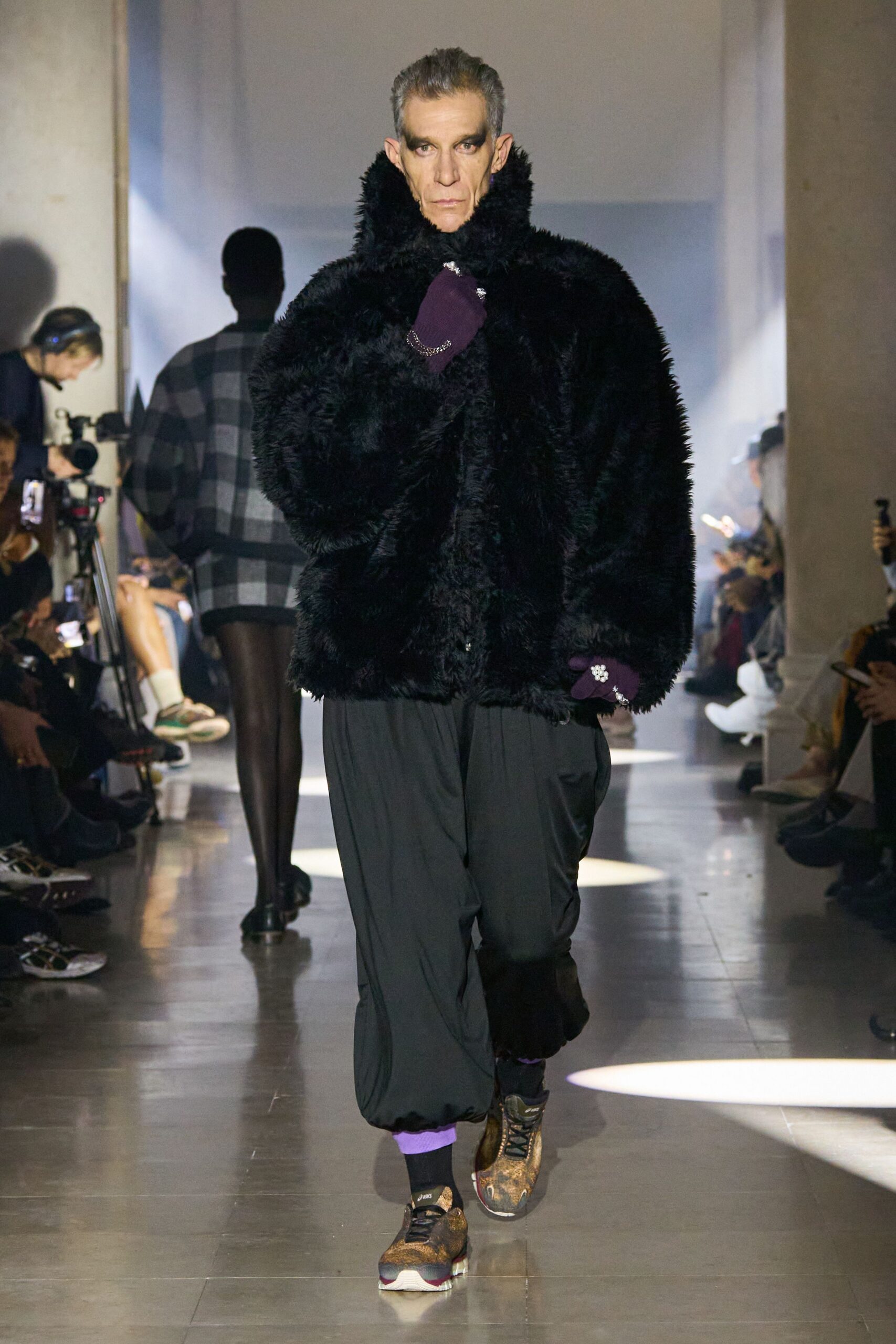 black faux-fur coat with relaxed pants