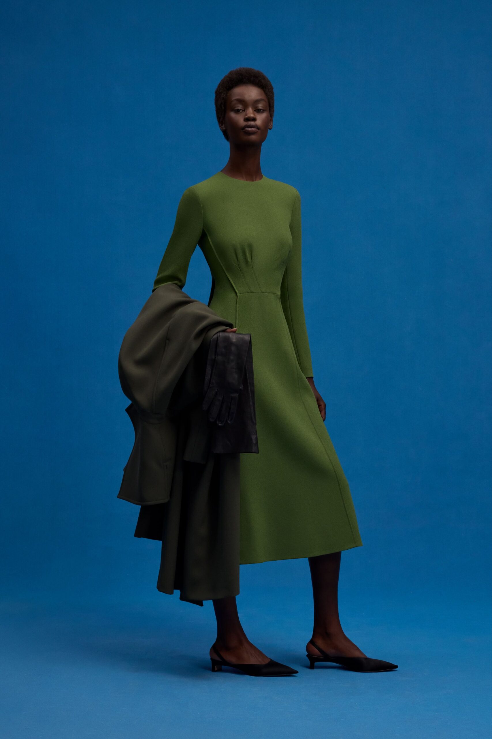 green fitted midi dress with coat