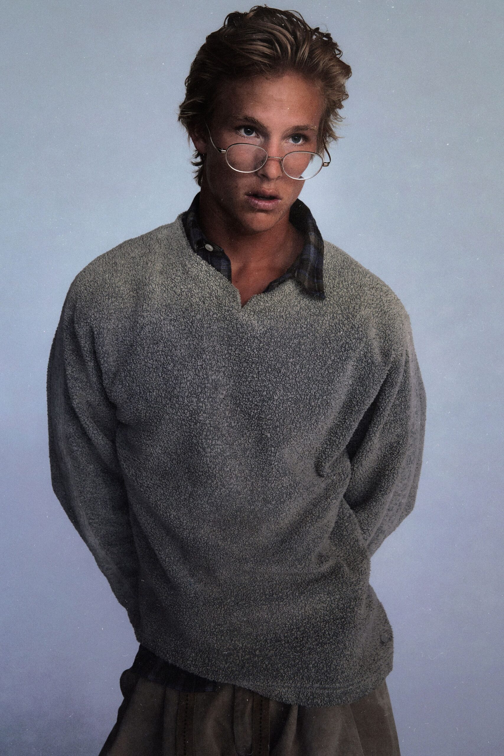 gray relaxed sweater with plaid shirt