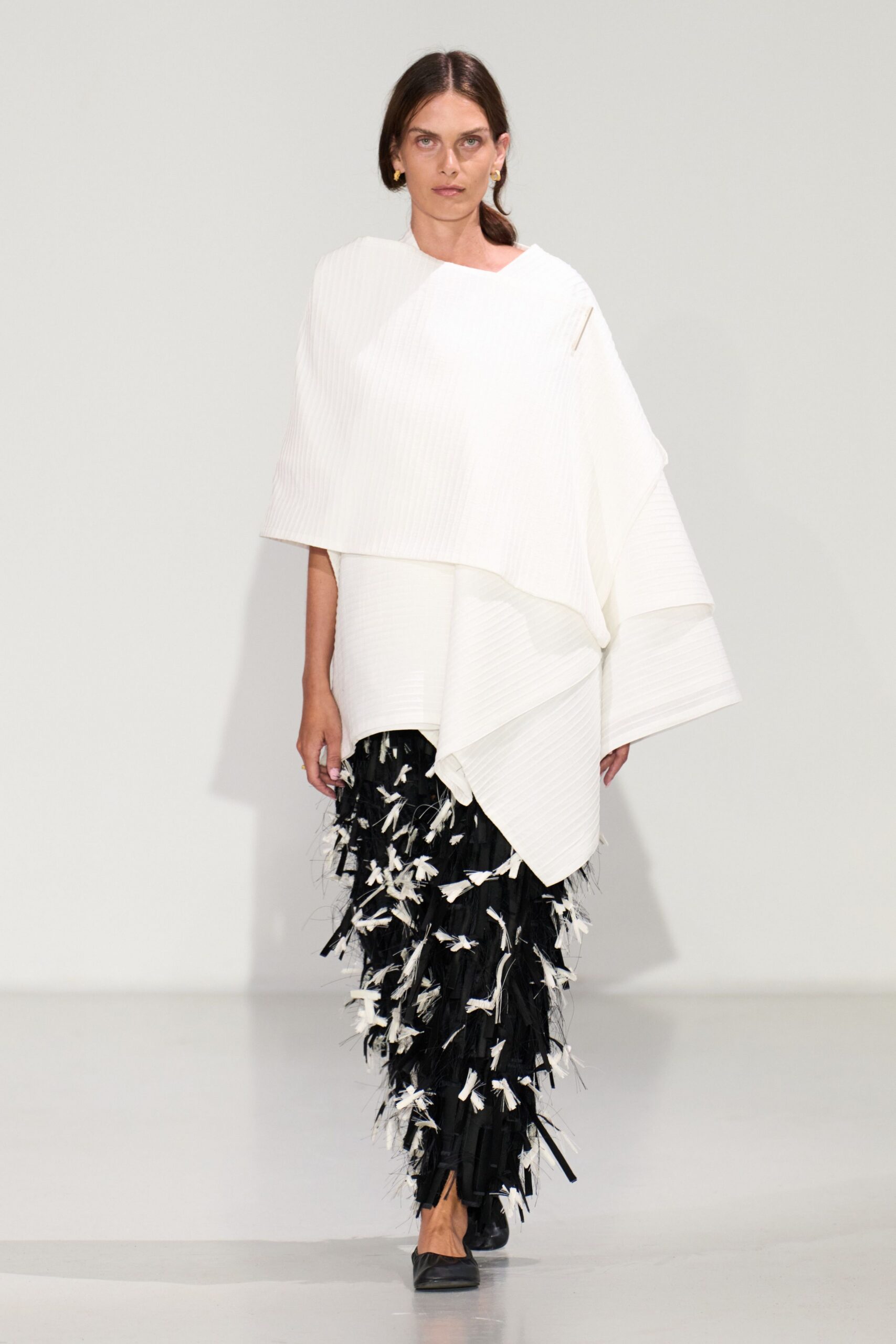 white asymmetric top black fringed pants