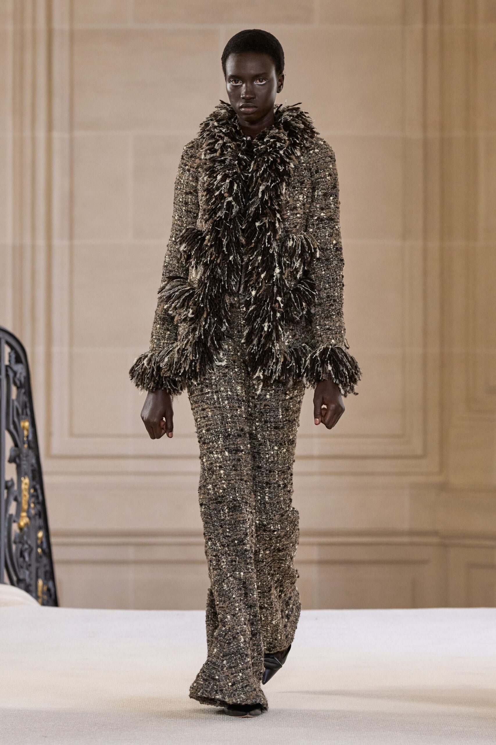 black and brown fringed jacket with fitted pants