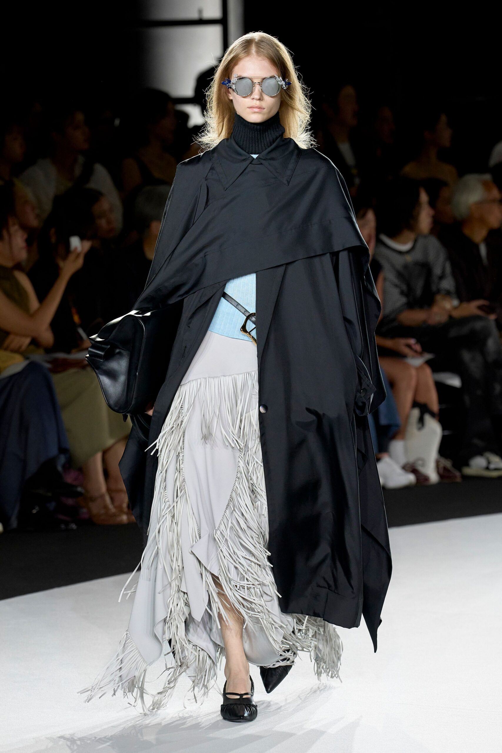 black cape with blue top and gray skirt
