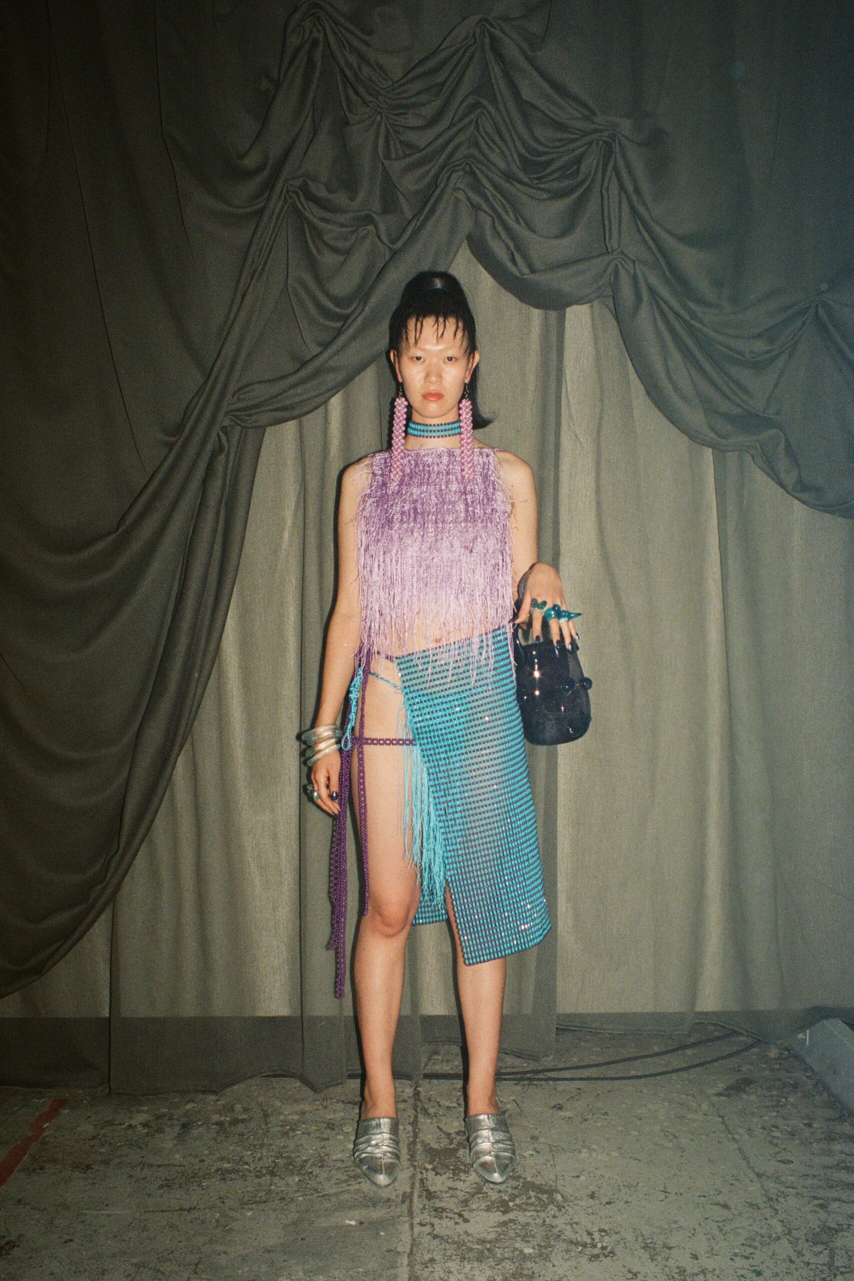 purple fringed top and blue skirt
