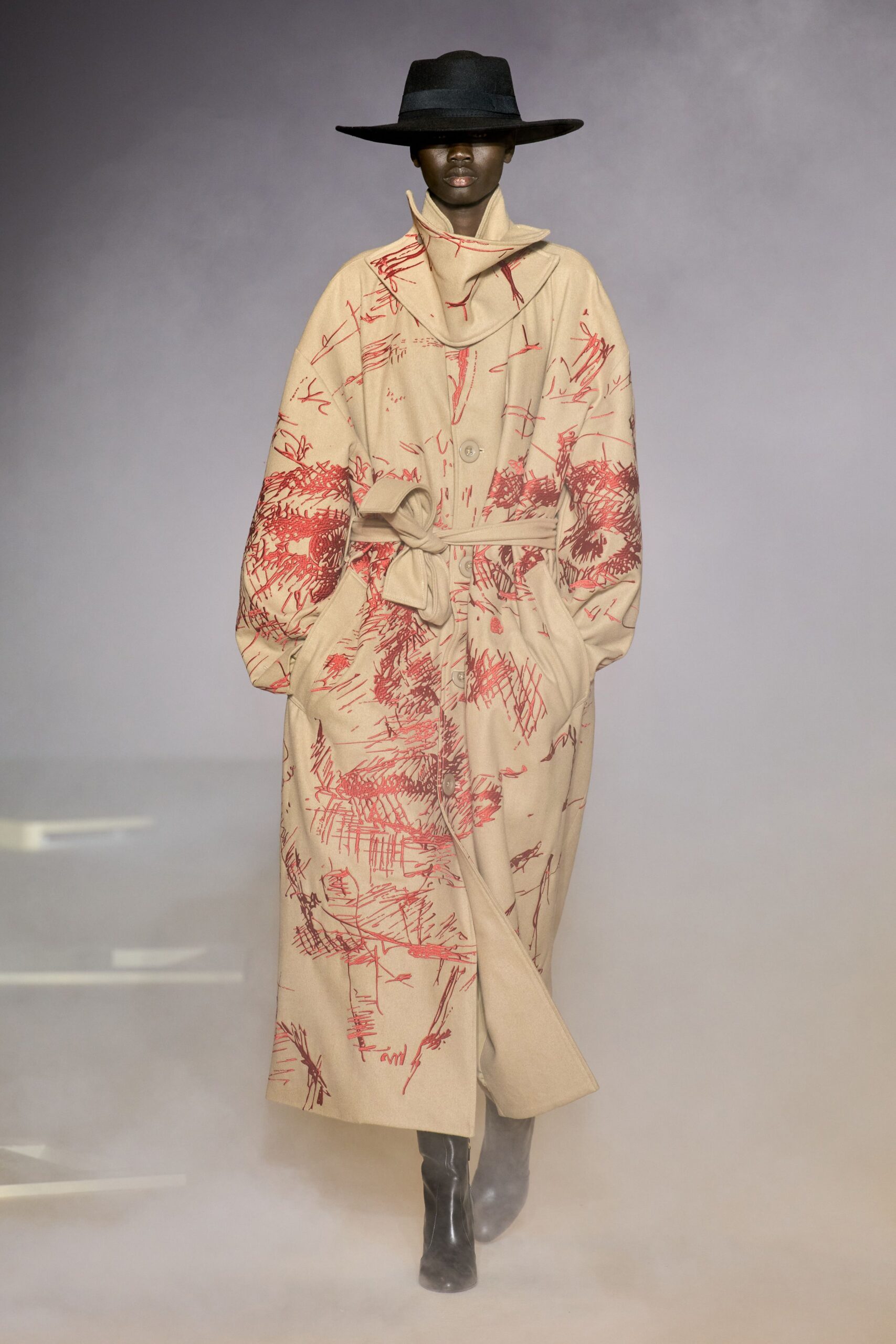 beige printed relaxed coat with black hat