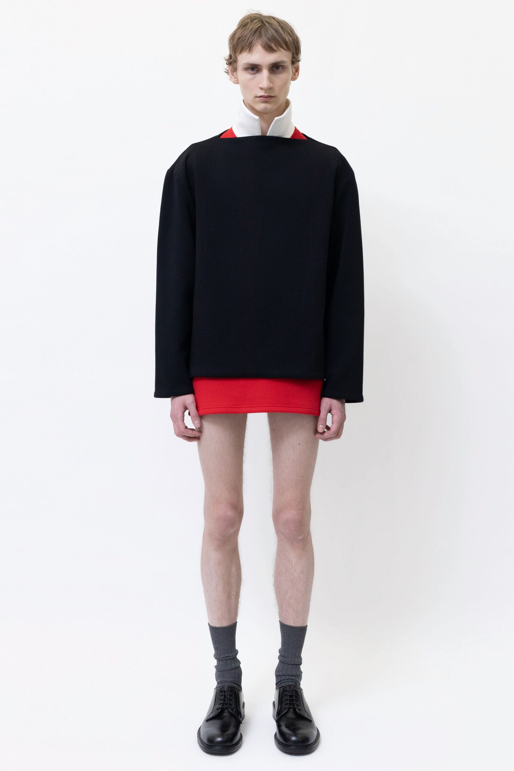 black oversized top red mini skirt