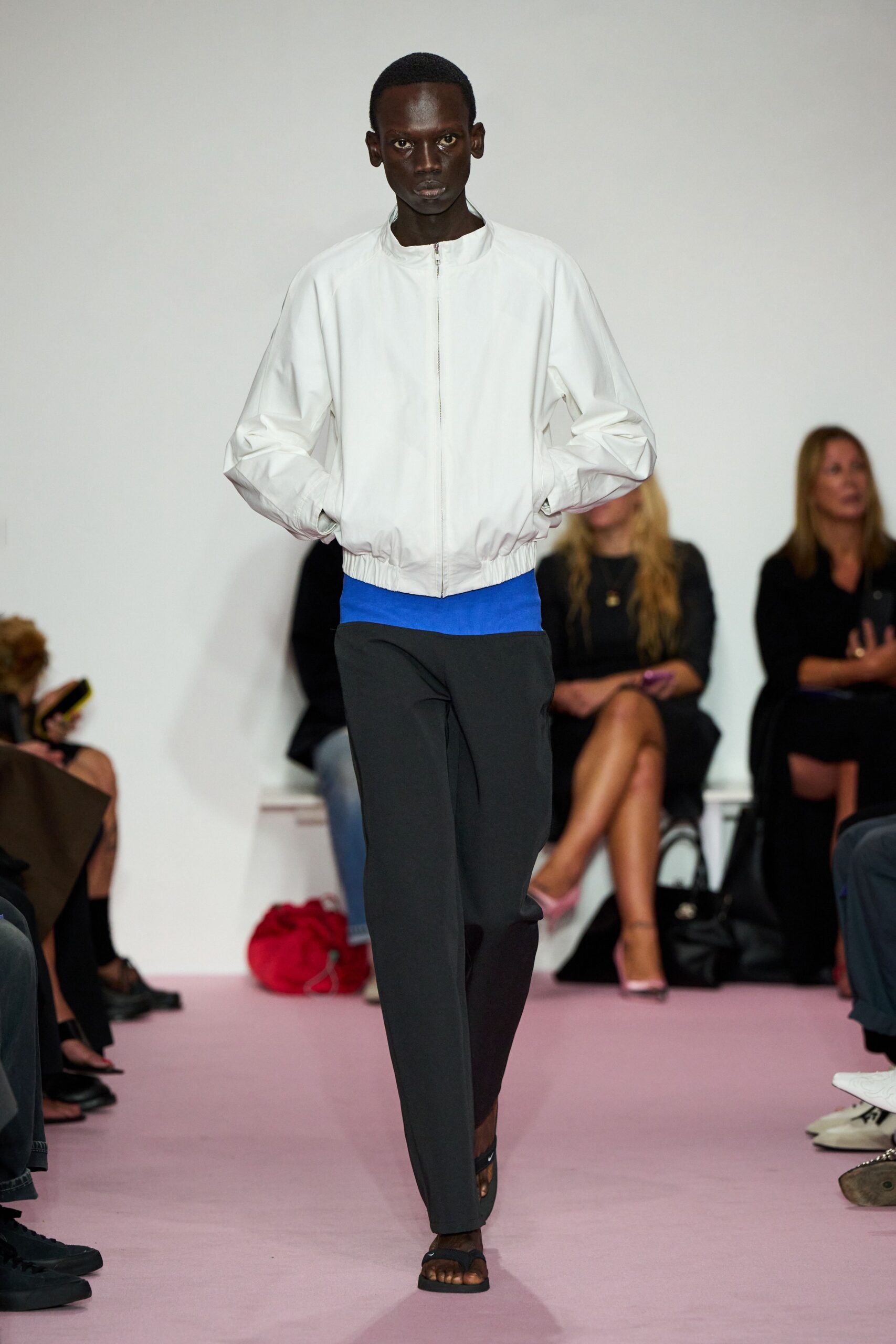 white jacket blue top gray pants