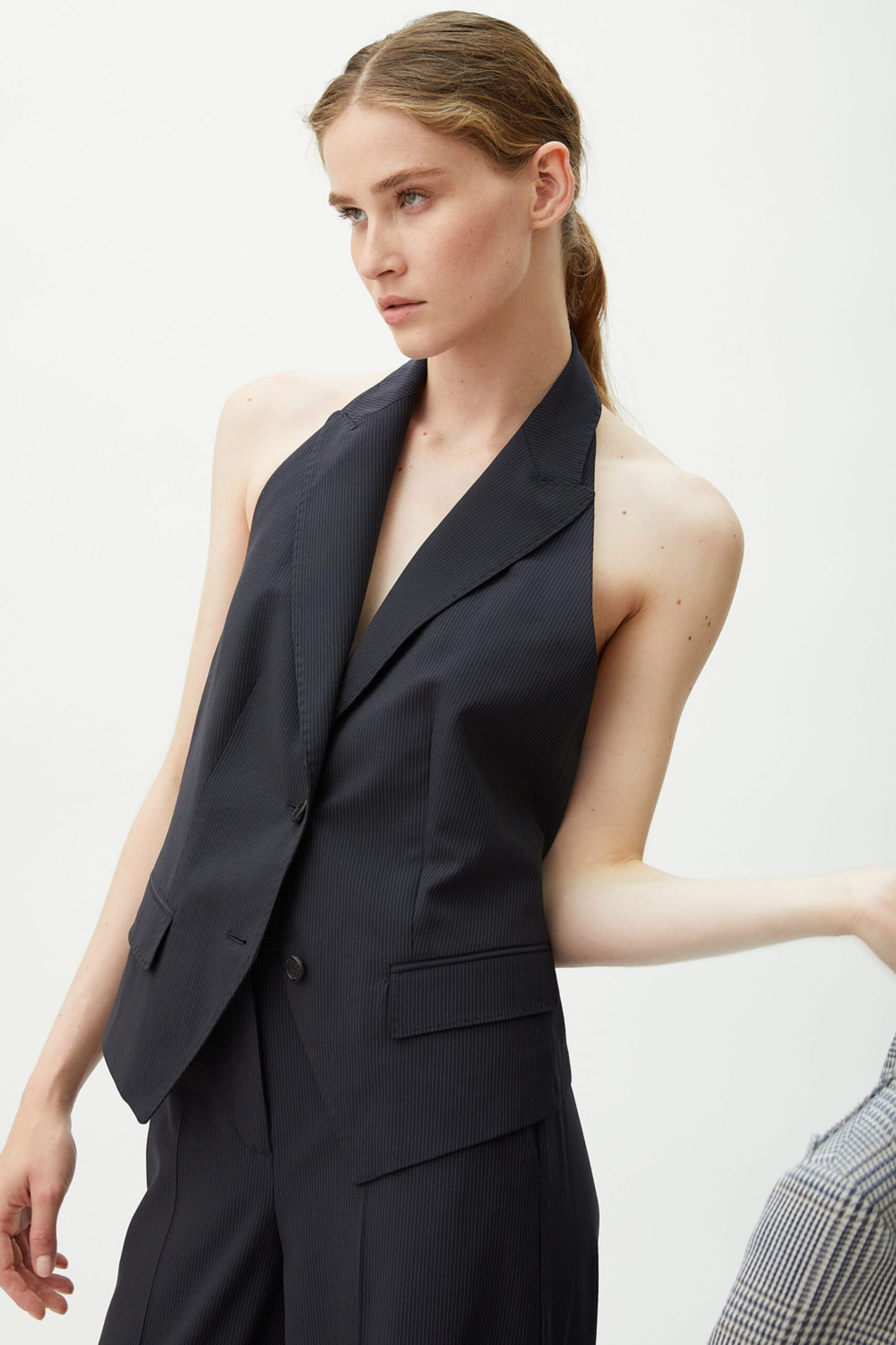 black fitted sleeveless blazer and tailored pants