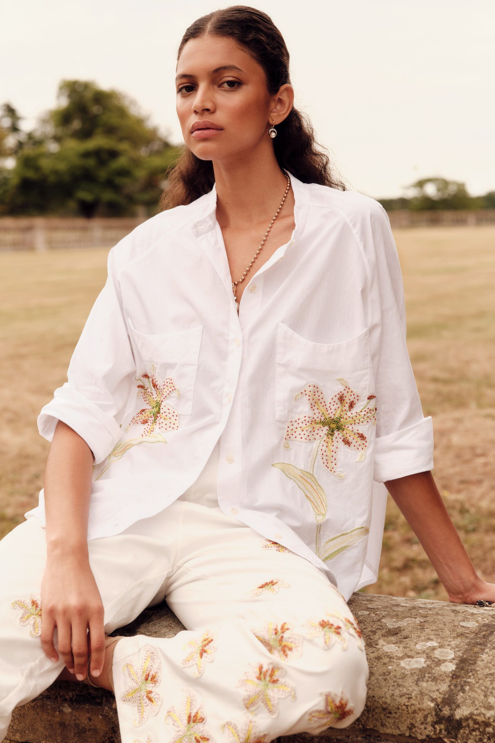 white embroidered shirt and pants