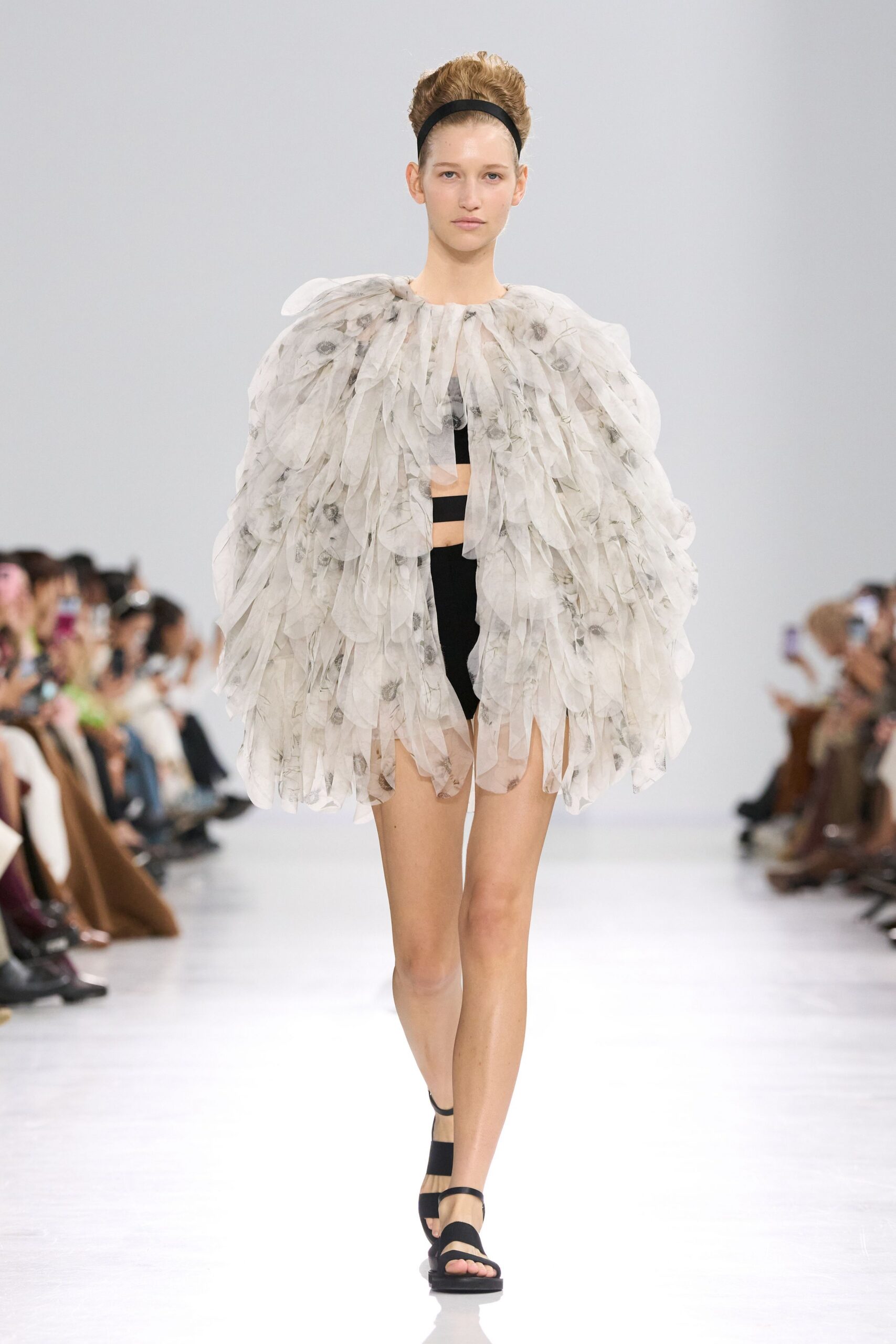 white ruffled cape black top and shorts