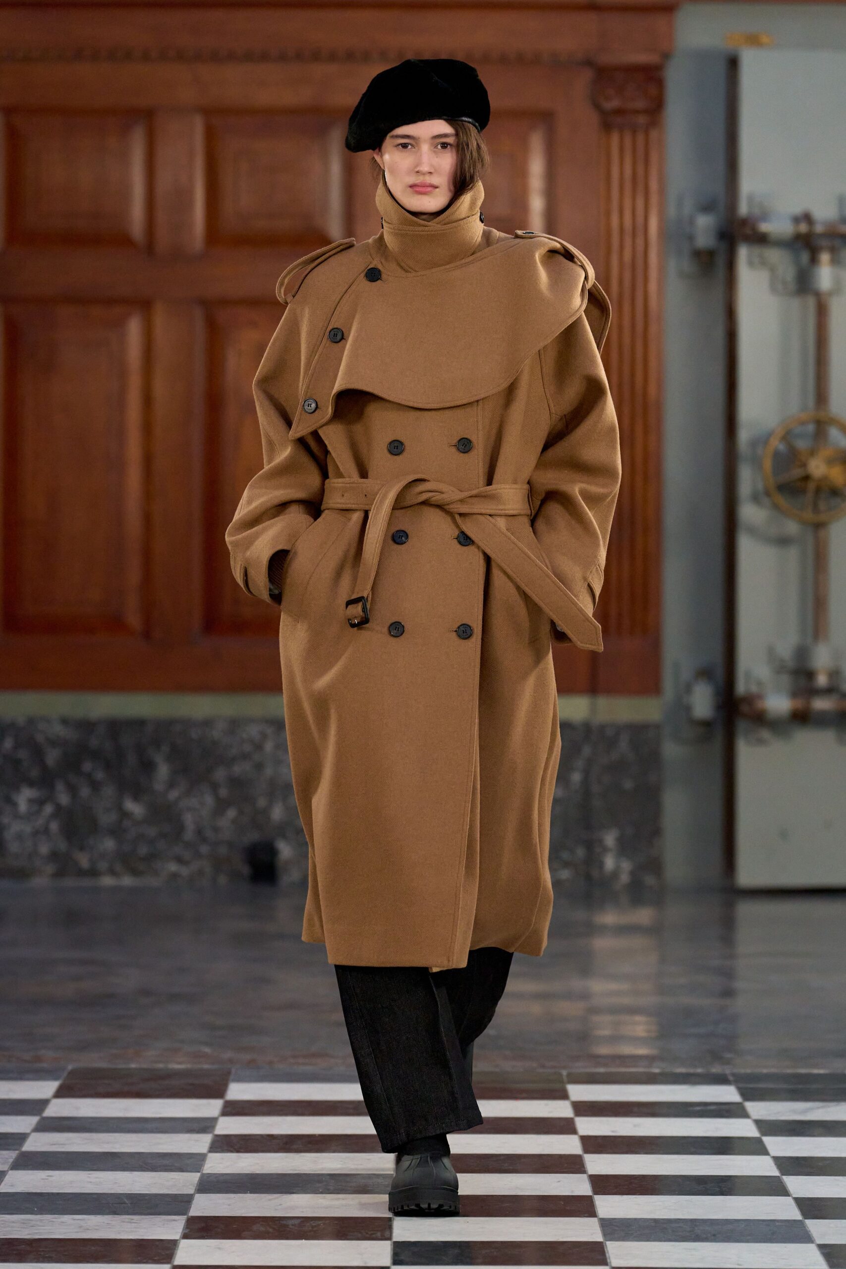 brown wool coat with black pants and hat