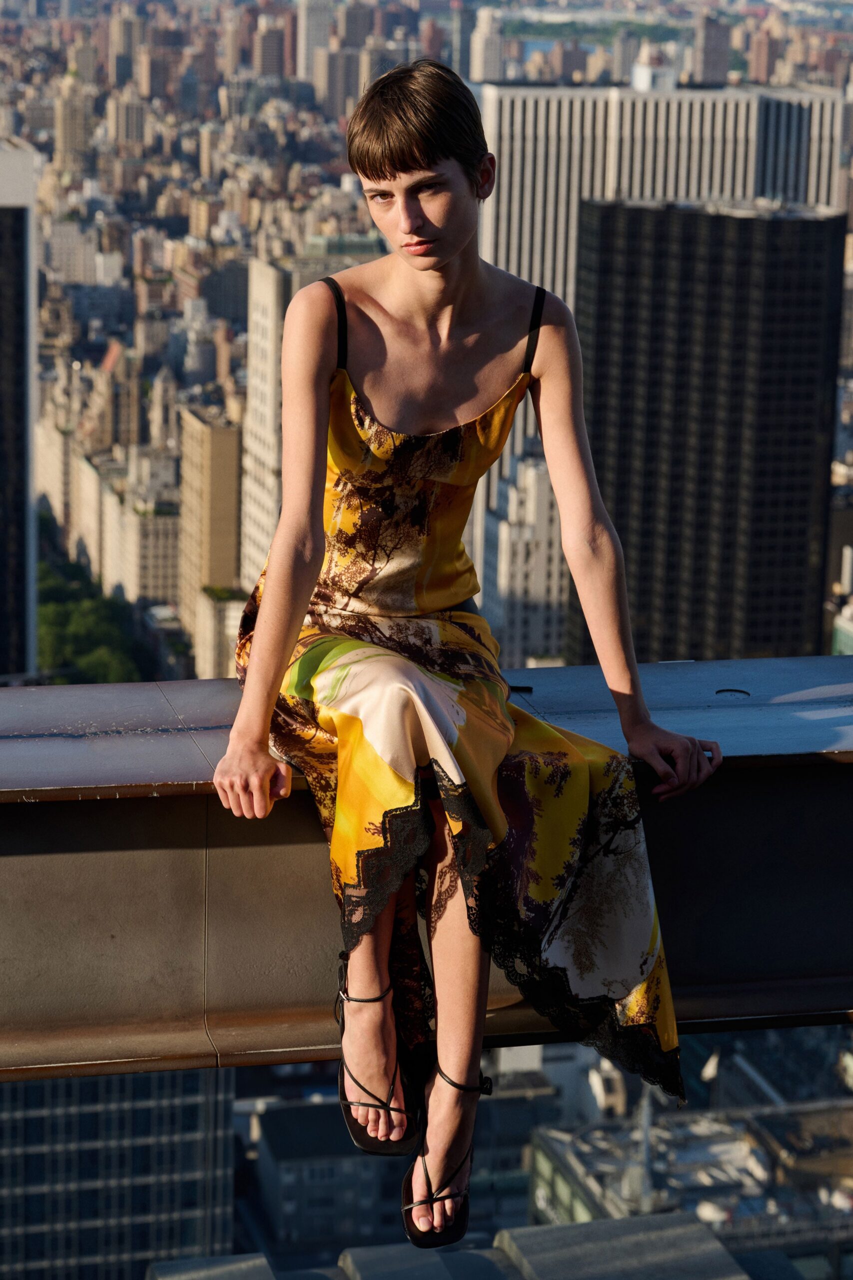 yellow silk midi dress with black shoes