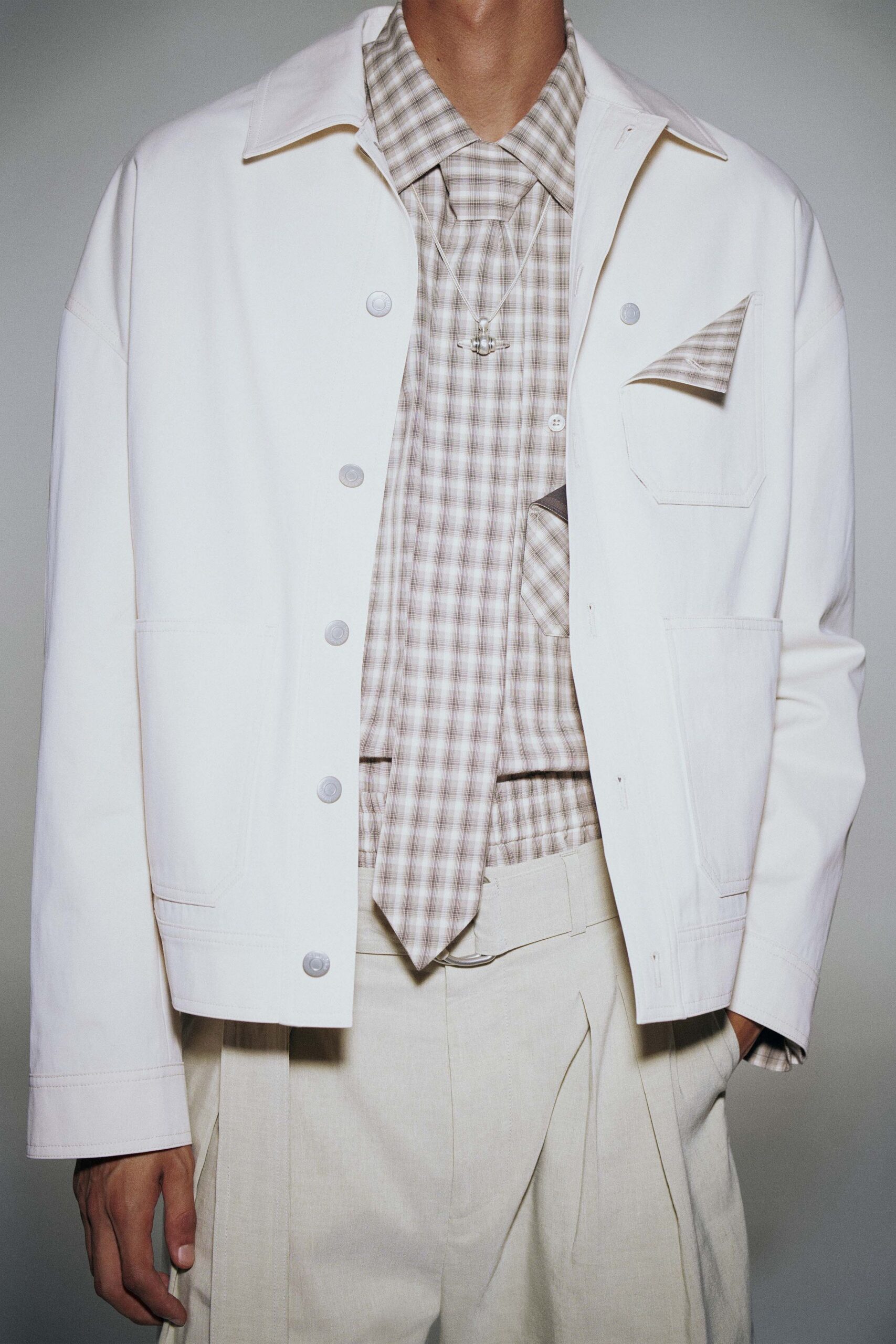 white jacket beige shirt and pants