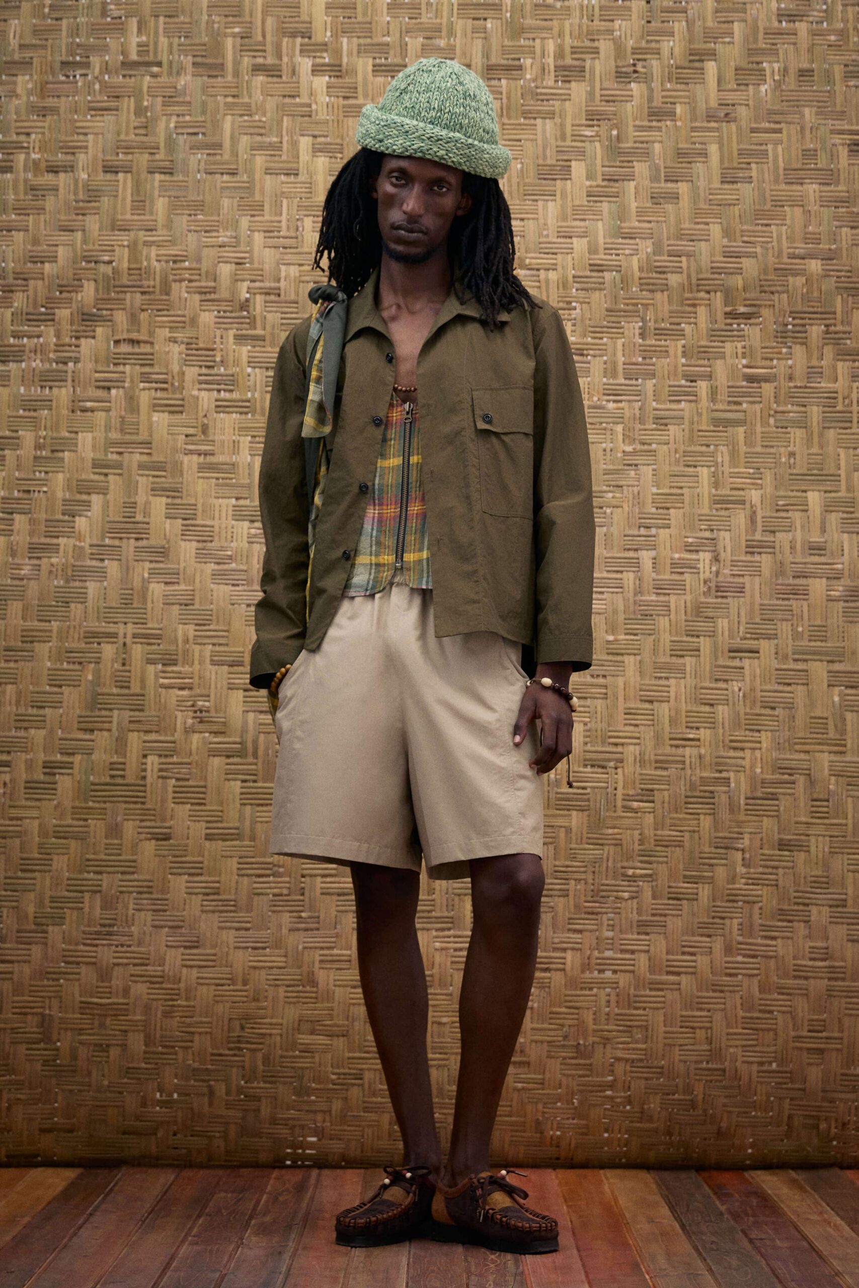 green jacket multi shirt beige shorts