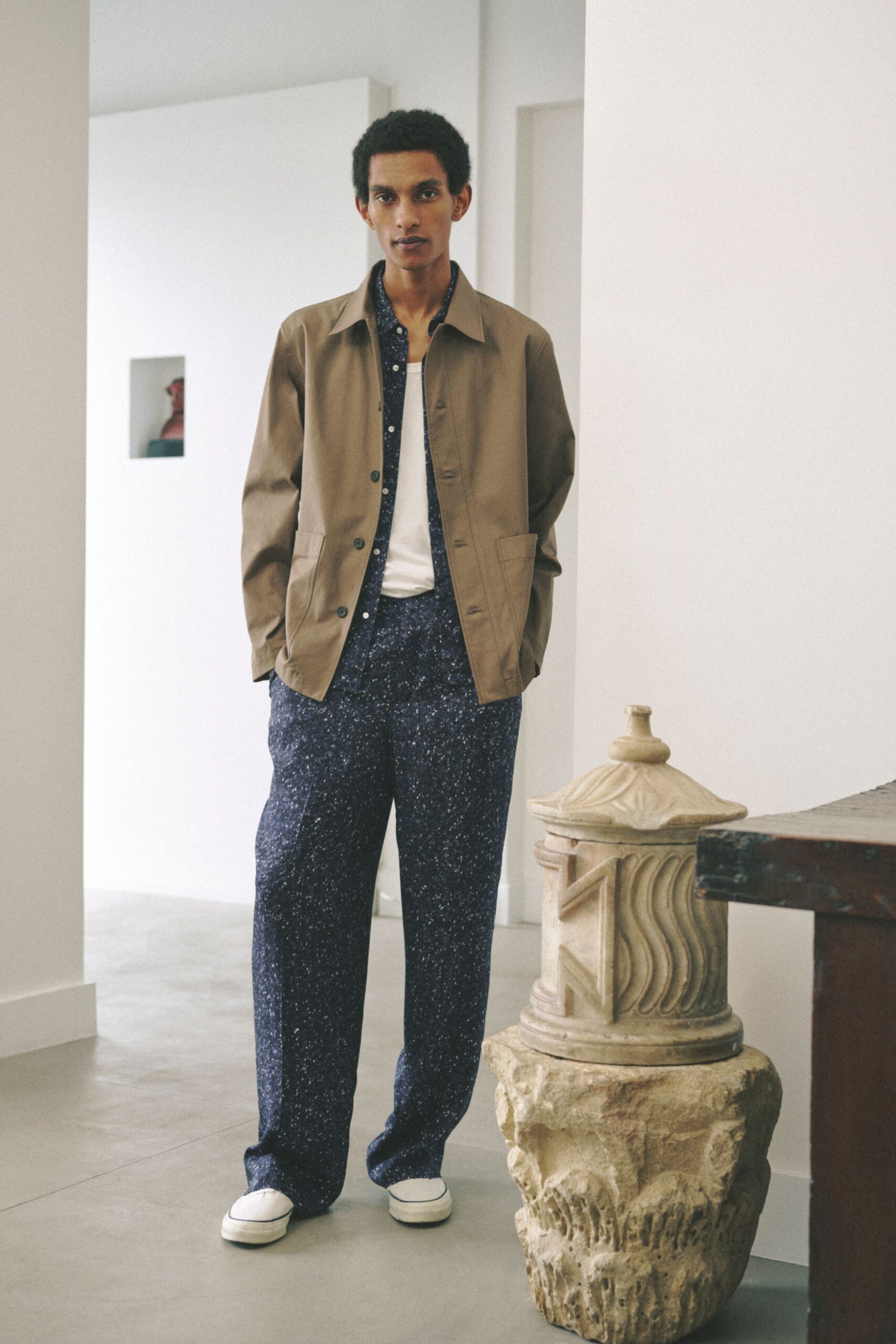beige jacket white shirt blue pants
