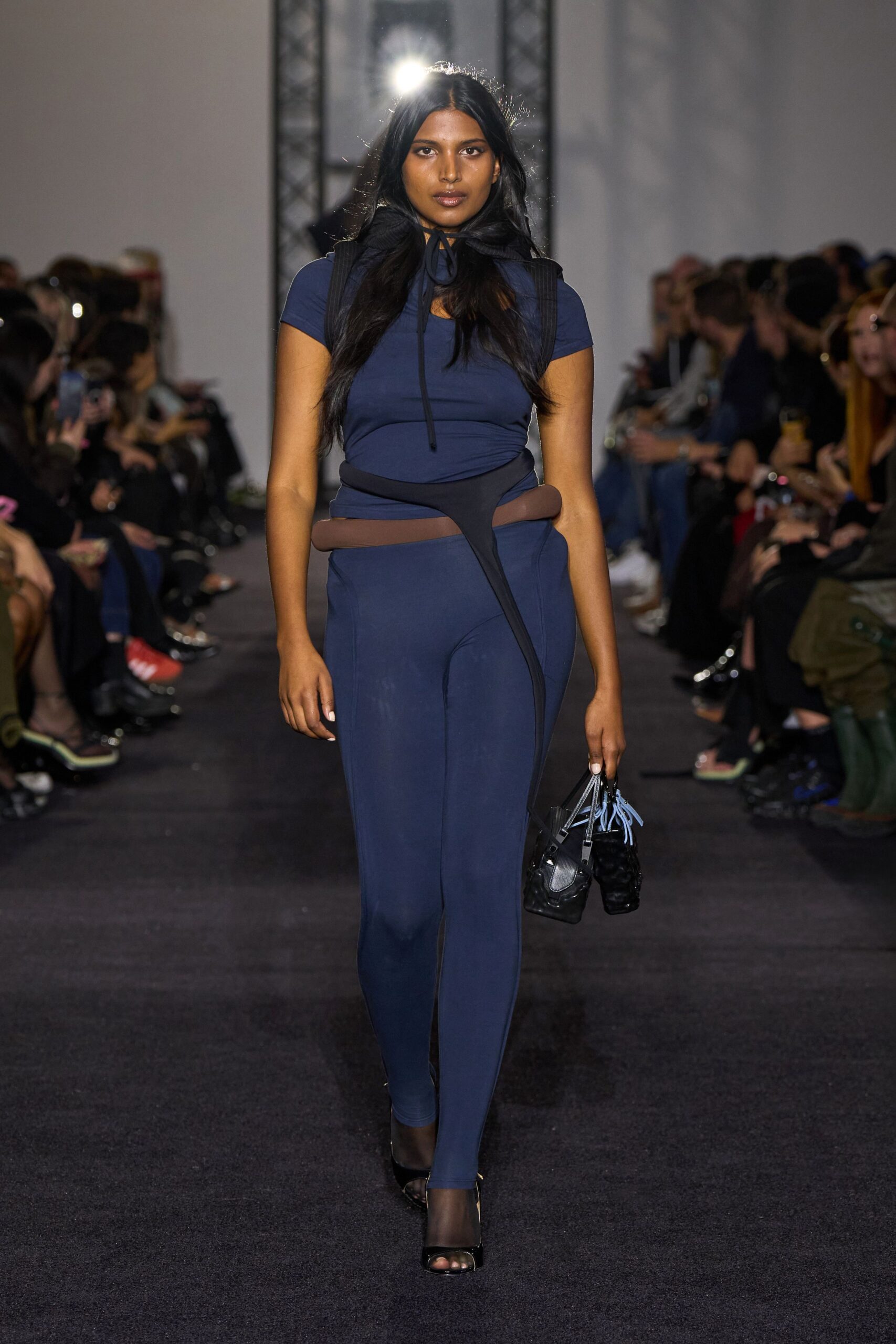 blue fitted catsuit with black shoes